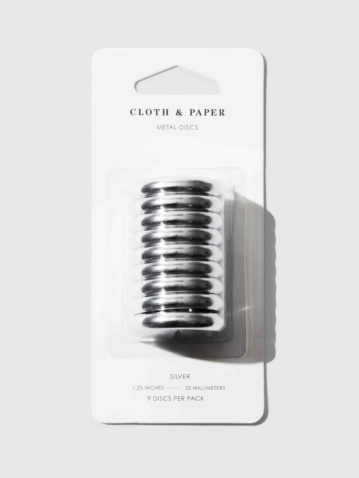 Silver discs displayed in their packaging on a gray background.