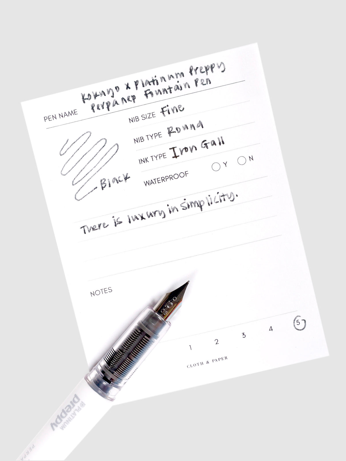 Kokuyo x Platinum Preppy Perpanep Fountain Pen, Cloth and Paper. Pen resting on pen test sheet displaying writing sample.