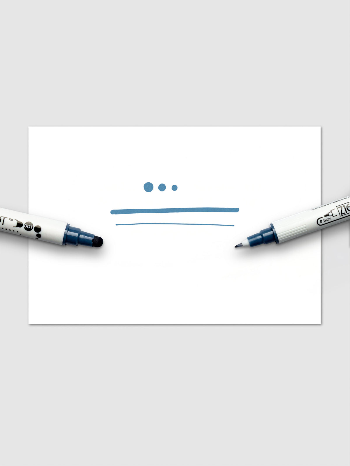 Sample swatch using the Denim marker, featuring expressive strokes and dots created by both marker tips on white paper.
