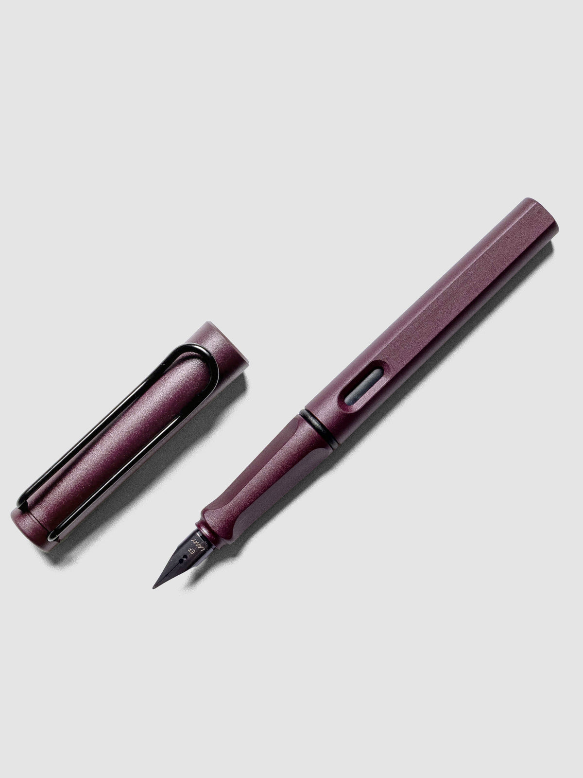 LAMY Safari Fountain Pen in the color Scarlett with Extra Fine nib shown diagonally with the cap off.