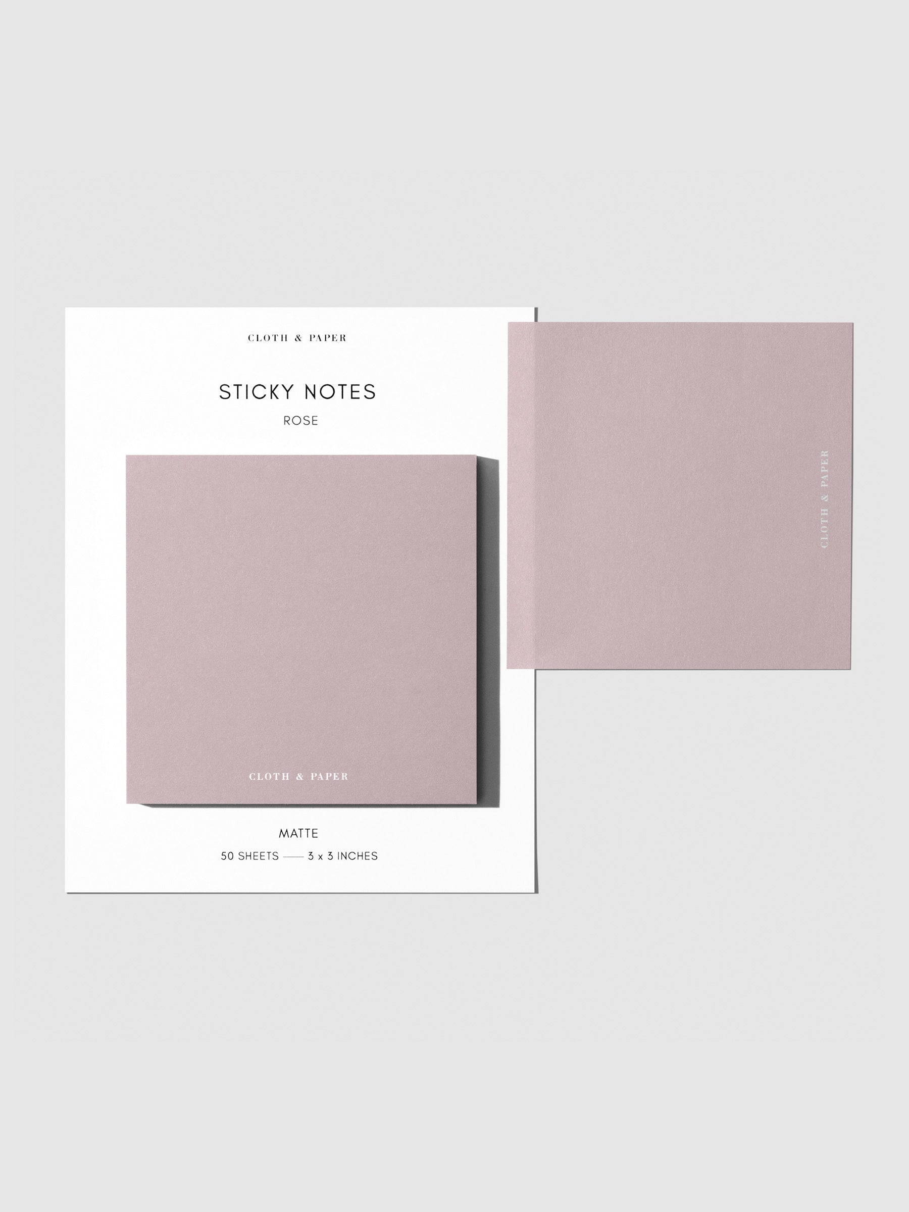 Sticky note set displayed against a neutral background. One note is placed on the packaging's edge. Color shown is Rose.