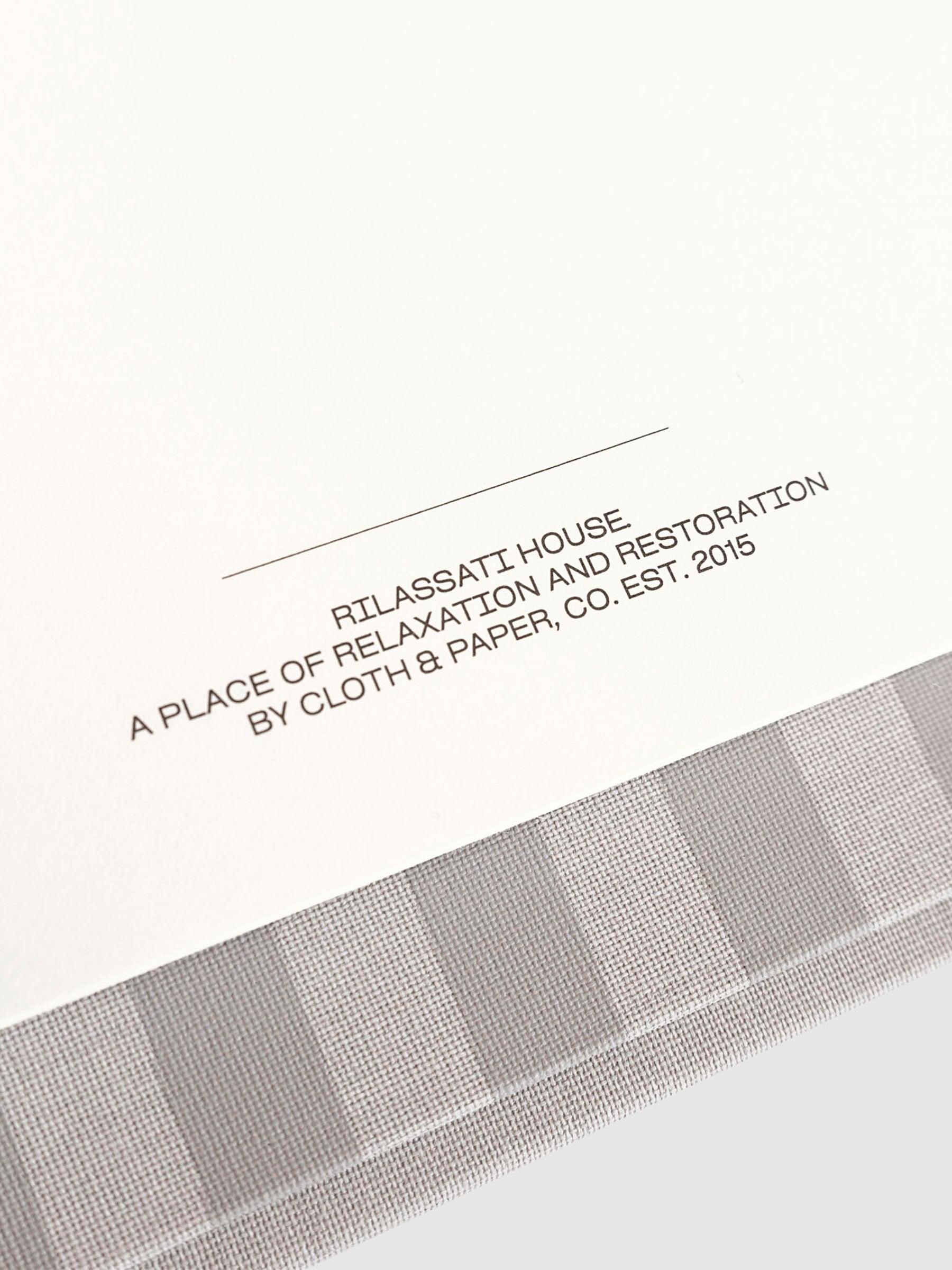 Closeup of Rilassati House text printed inside folio. Text reads "Relaxation and Restoration / Cloth & Paper Co. / Est. 2015"