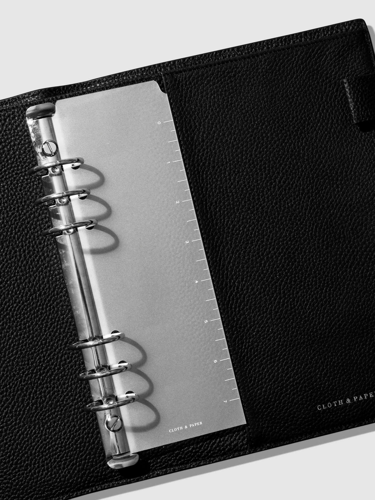 Page marker in use inside a black leather agenda.