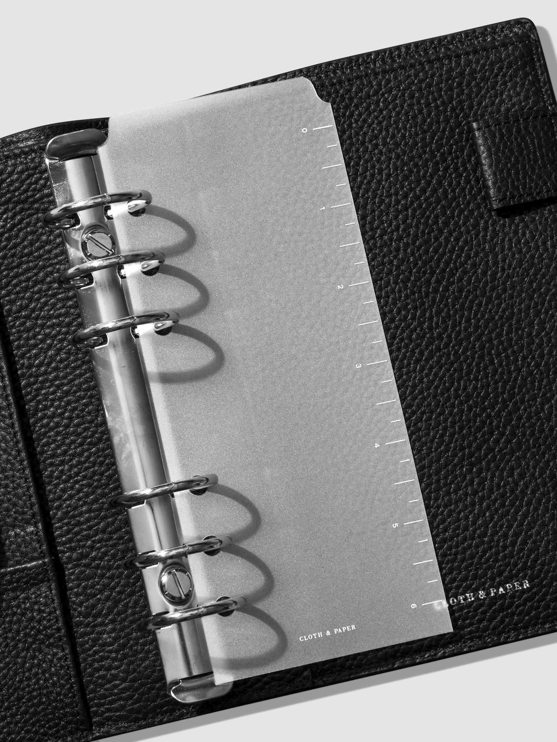 Page marker in use inside a black leather agenda.