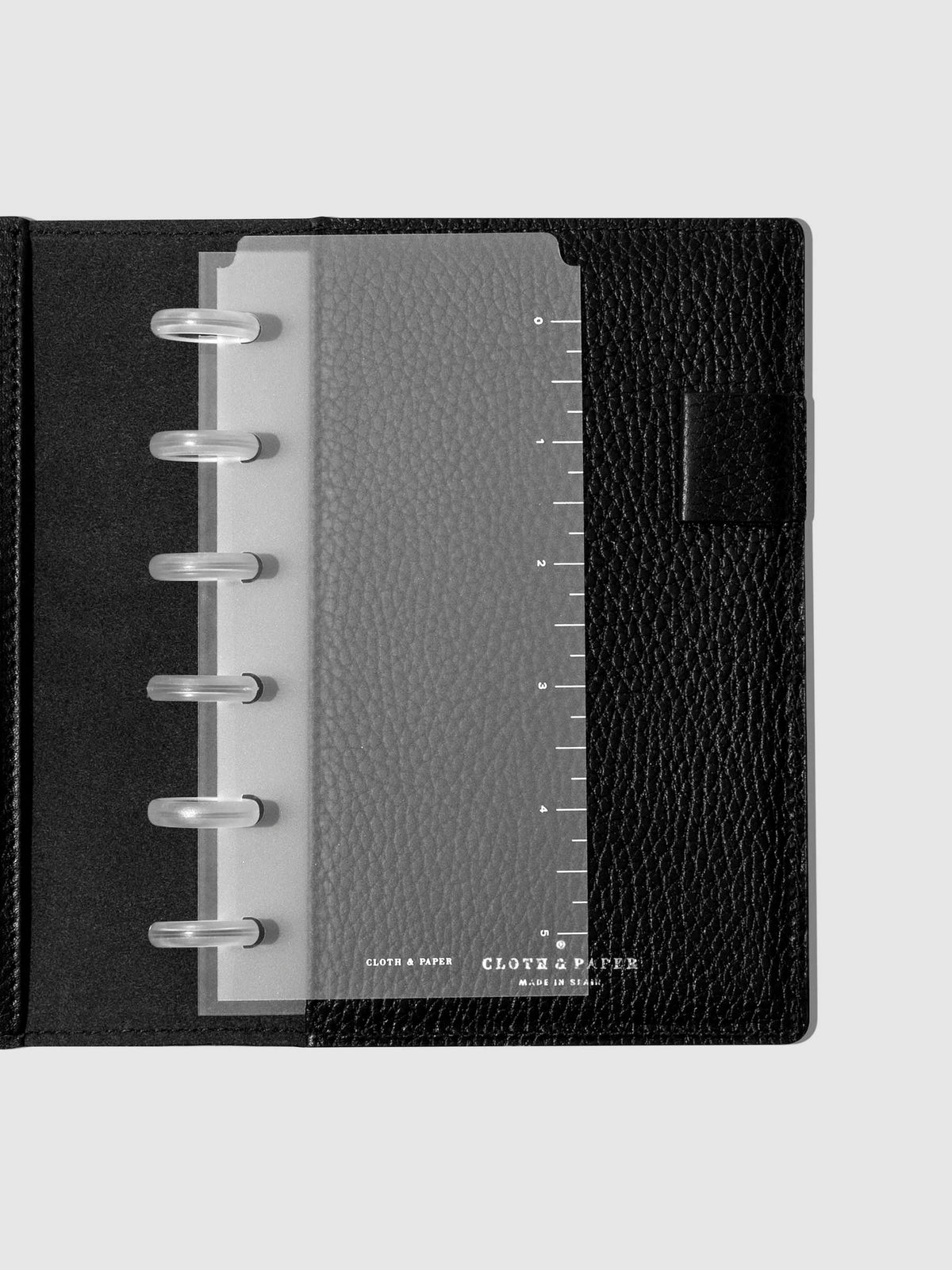 Page marker in use inside a black leather folio.