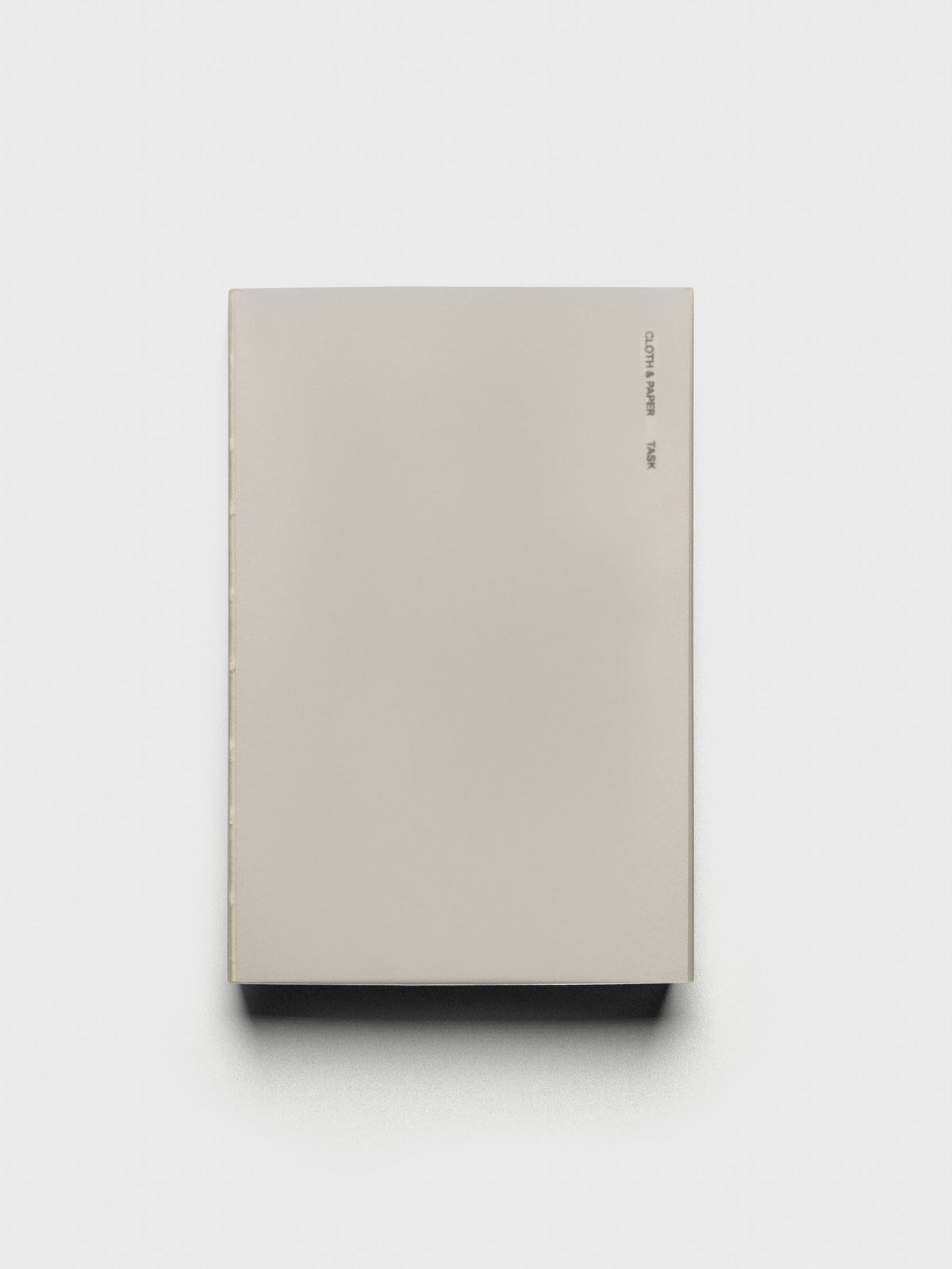 Perfect Bound Notebook | CP Petite | Task | Ristretto shown closed, laying flat, on a neutral background.