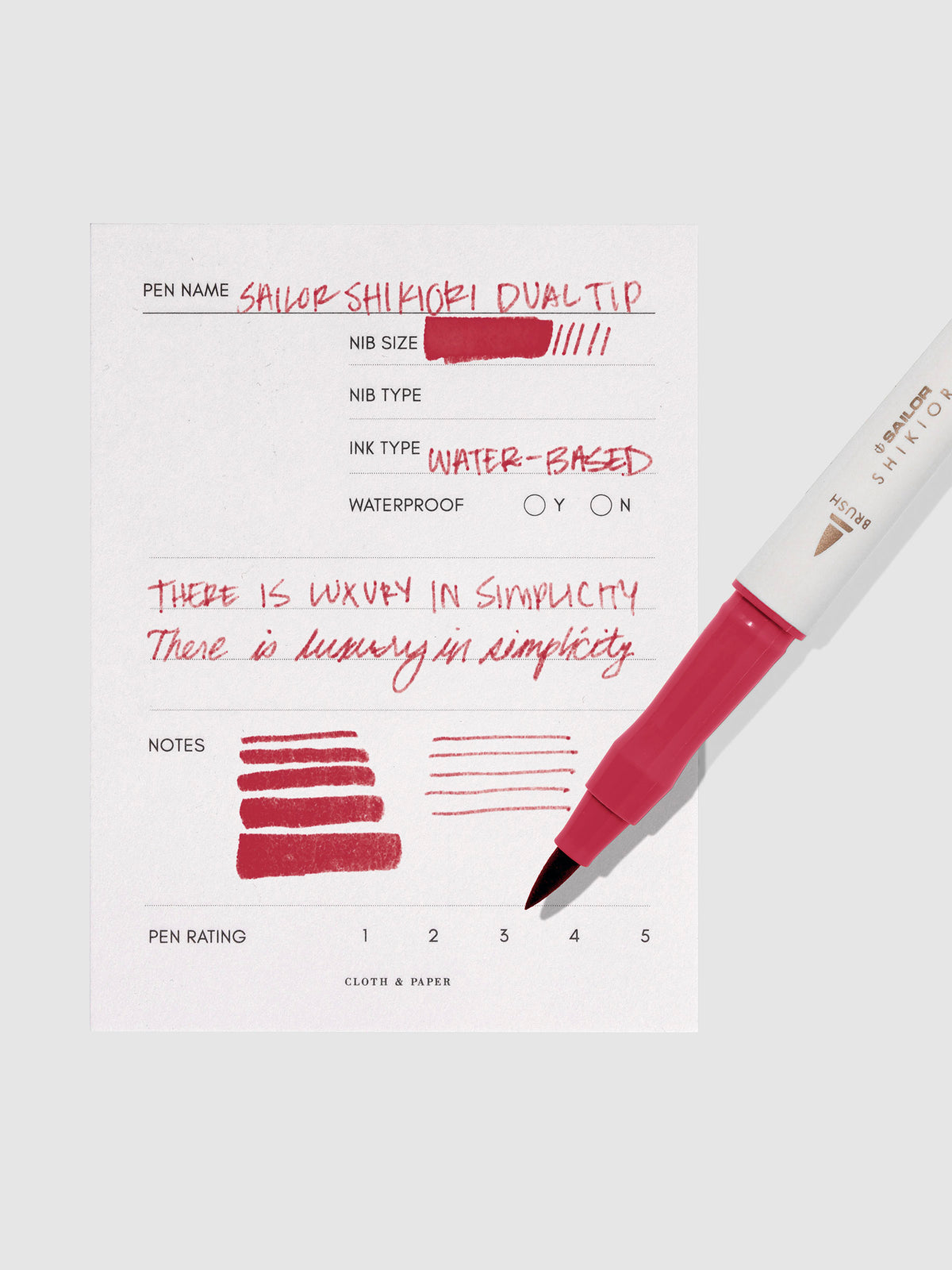 Pen displayed next to in use pen test sheet. Color pictured is Okuyama.