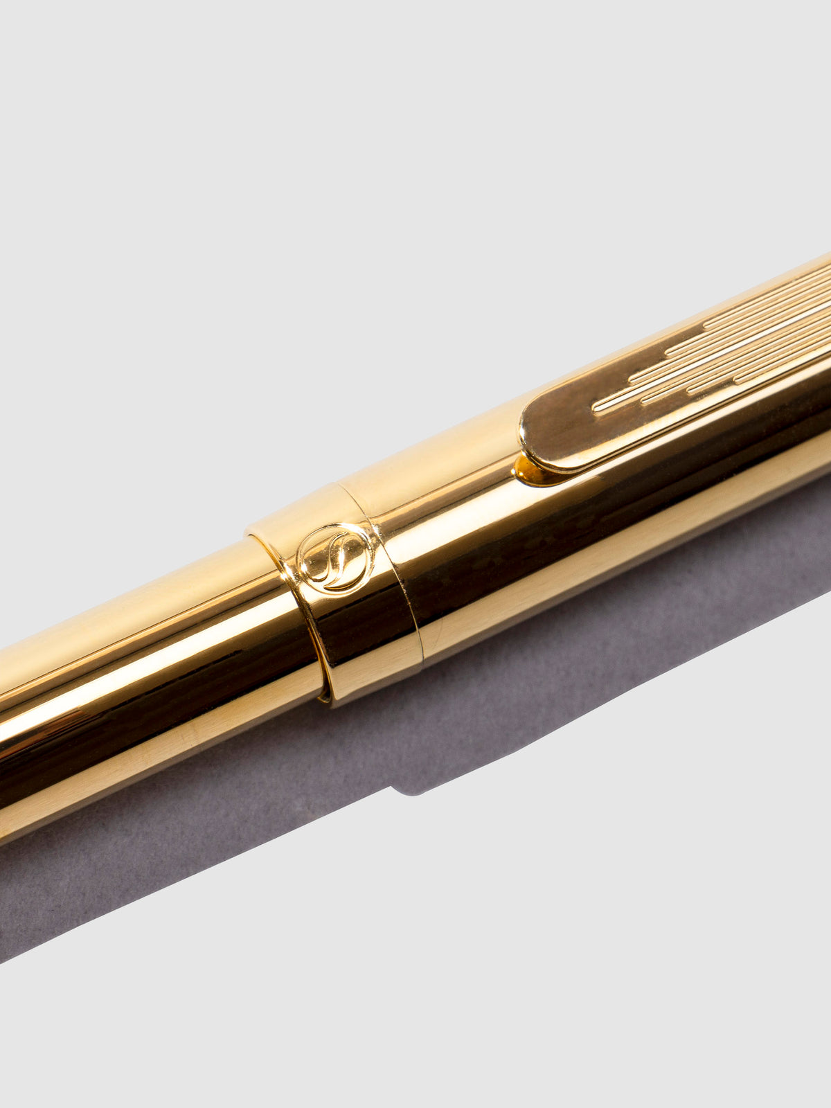 Closeup of pen showcasing a Scriveiner emblem.