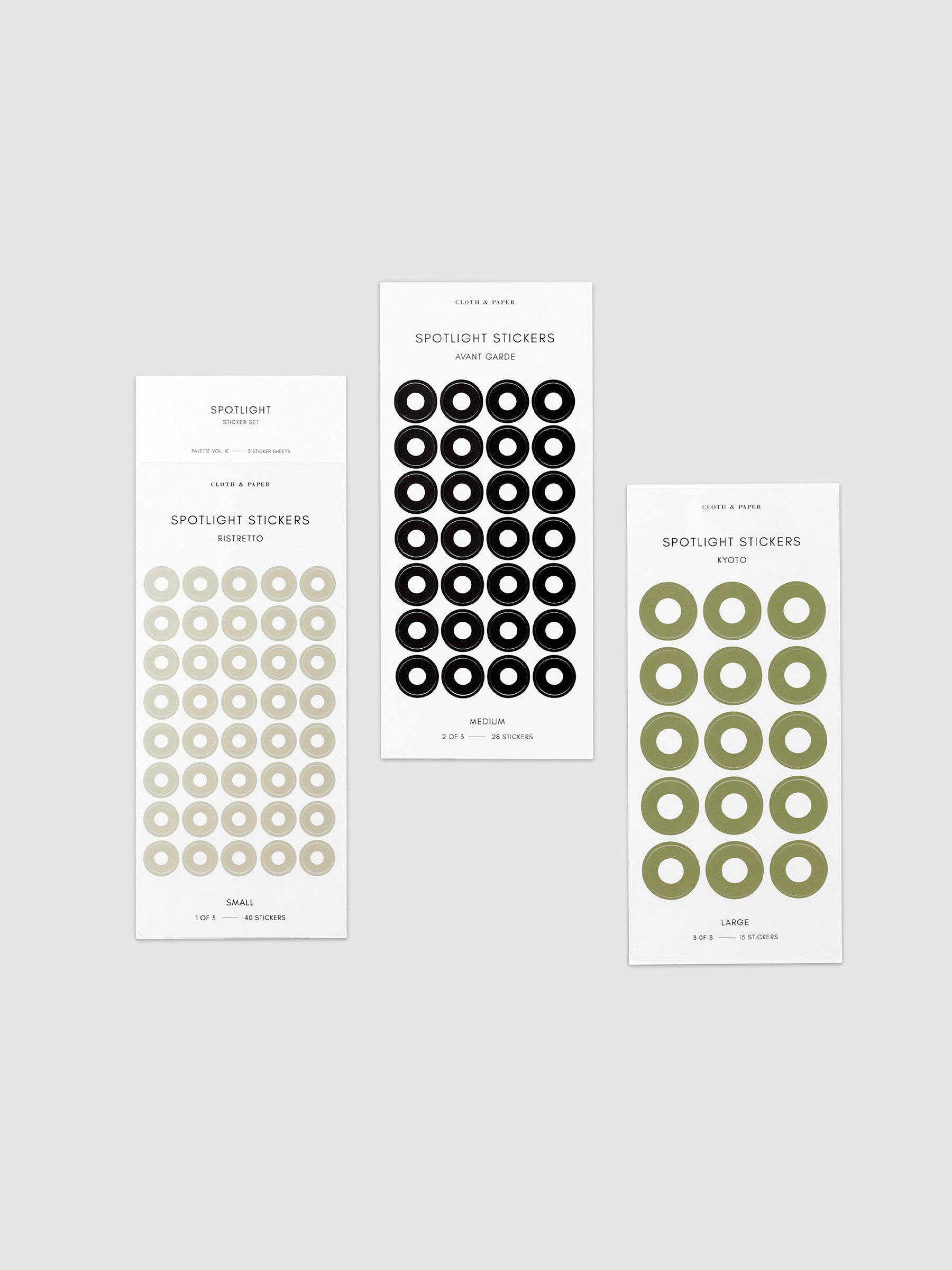 Three sheets of spotlight stickers in small, medium, and large sizing arranged together on a neutral background. Colors are ristretto, avant garde, and kyoto.