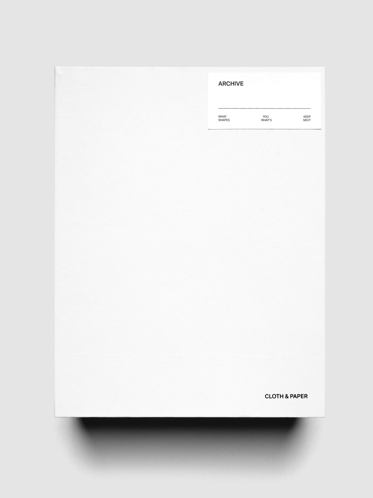 Storage Book 4.0 shown closed, laying flat, with Cloth & Paper logo on bottom right corner and Archive label sticker applied to top right corner.