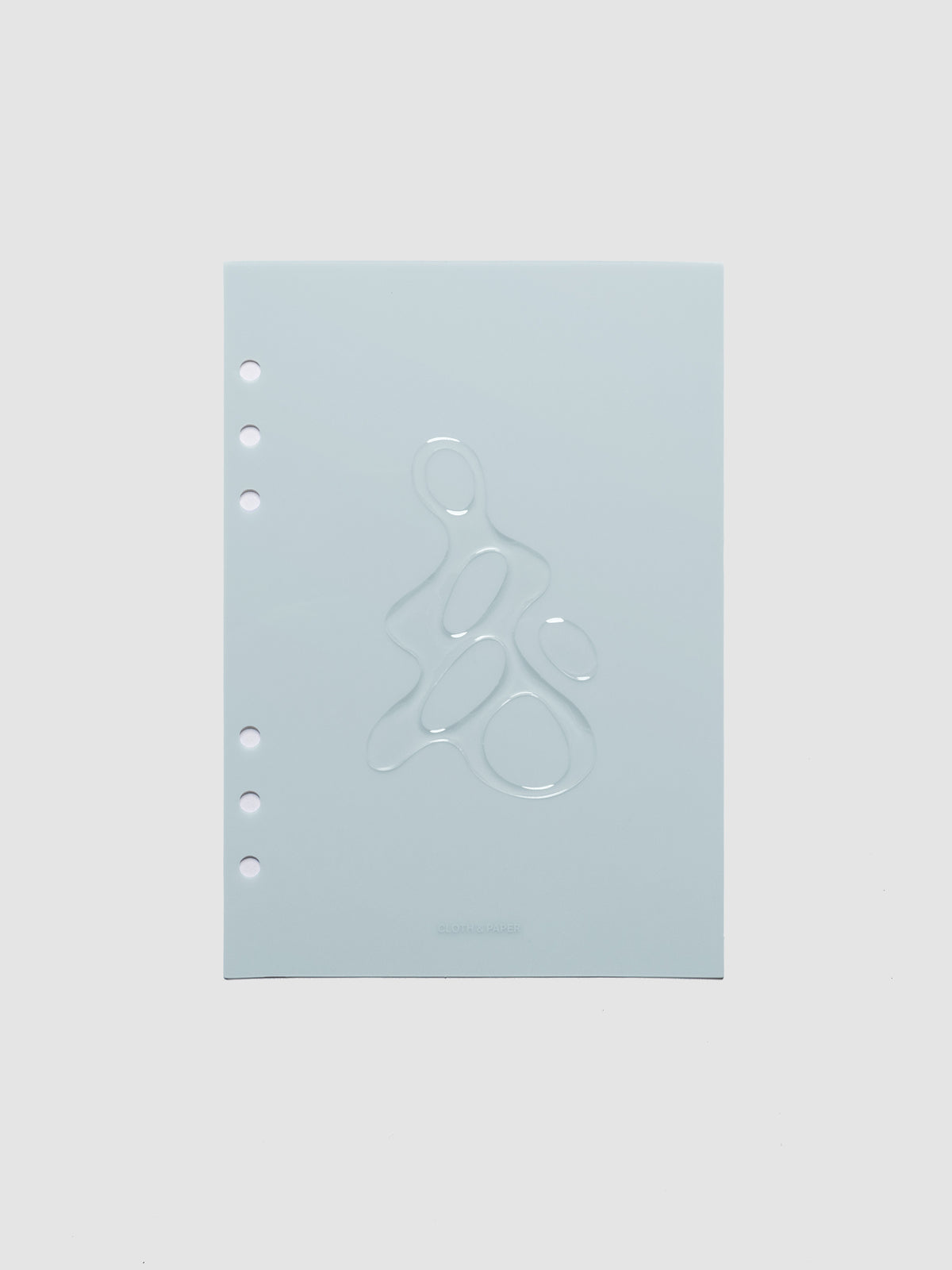 Light blue, semi-transparent, and glossy plastic planner dashboard with organic raised shape design in size A5 on a neutral background.