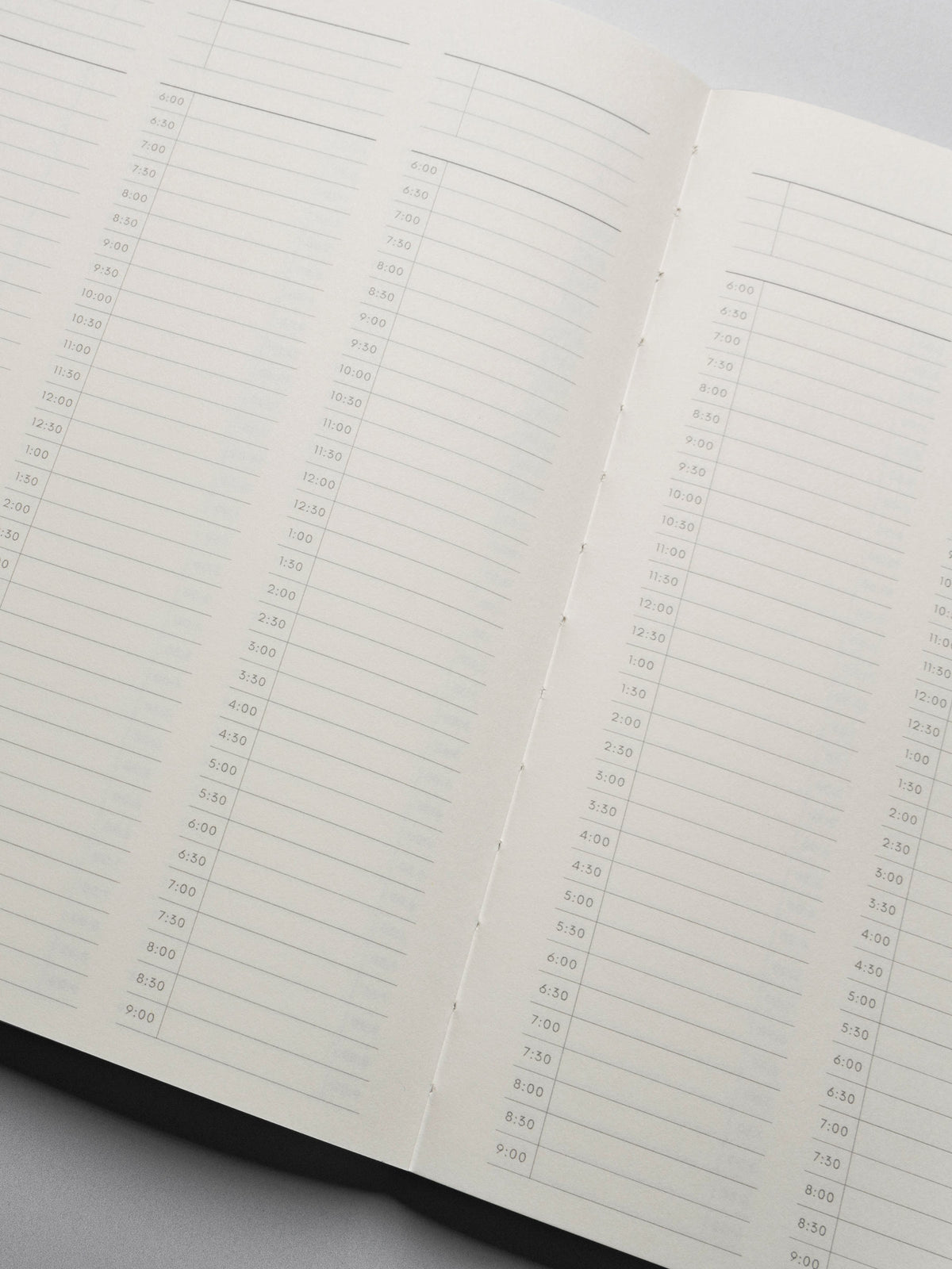 Perfect Bound Notebook in size HP Classic with 30 Minute Time Block pages shown close up showing the lay flat capabilities.