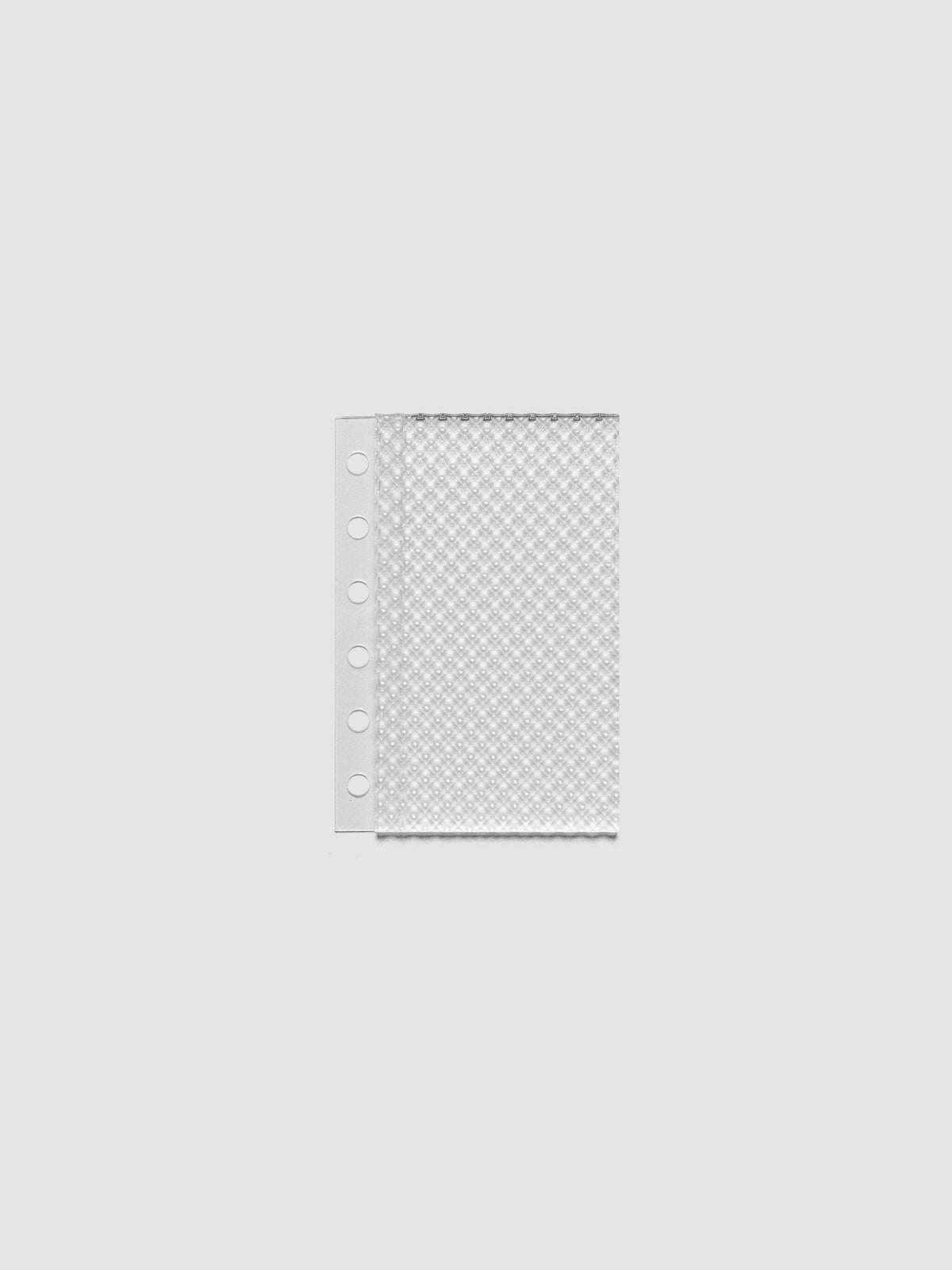 Clear, textured Studded Planner Dashboard in the size Pocket, on a neutral background.