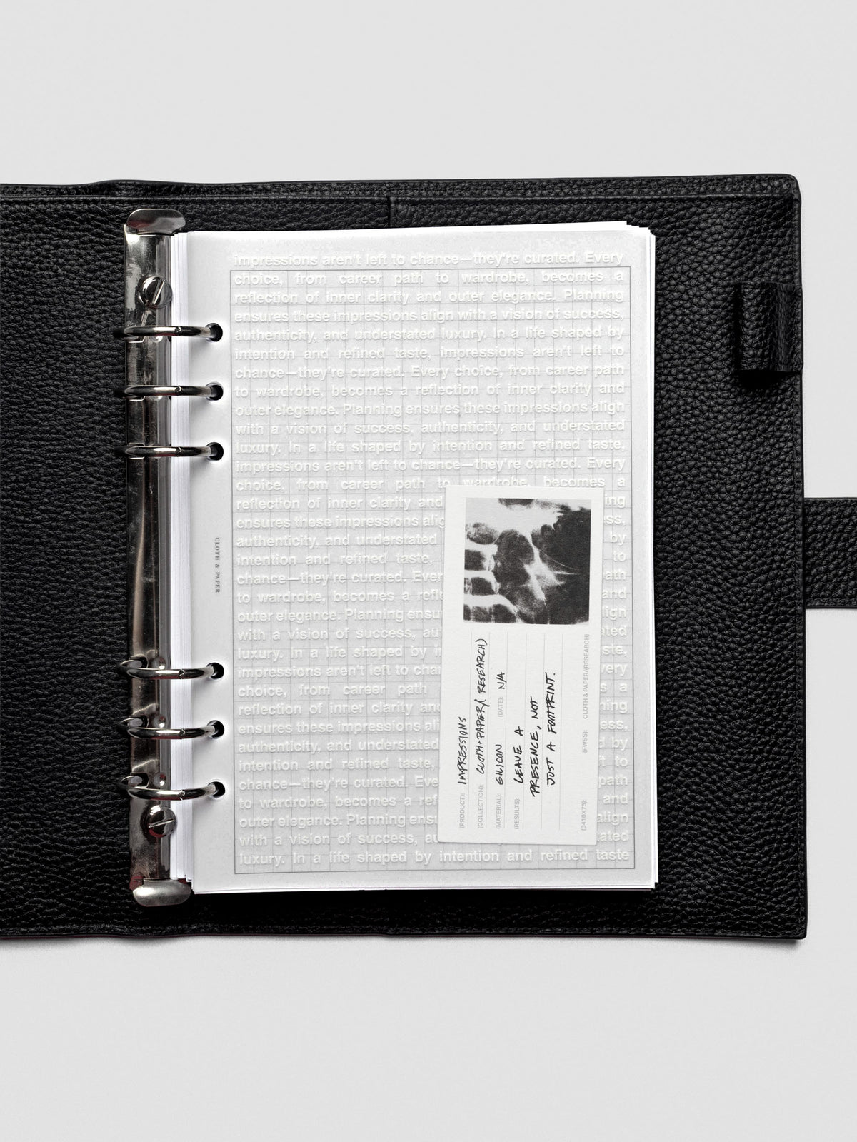 A5 Impressions Dashboard placed in an open planner, layered over minimal inserts.