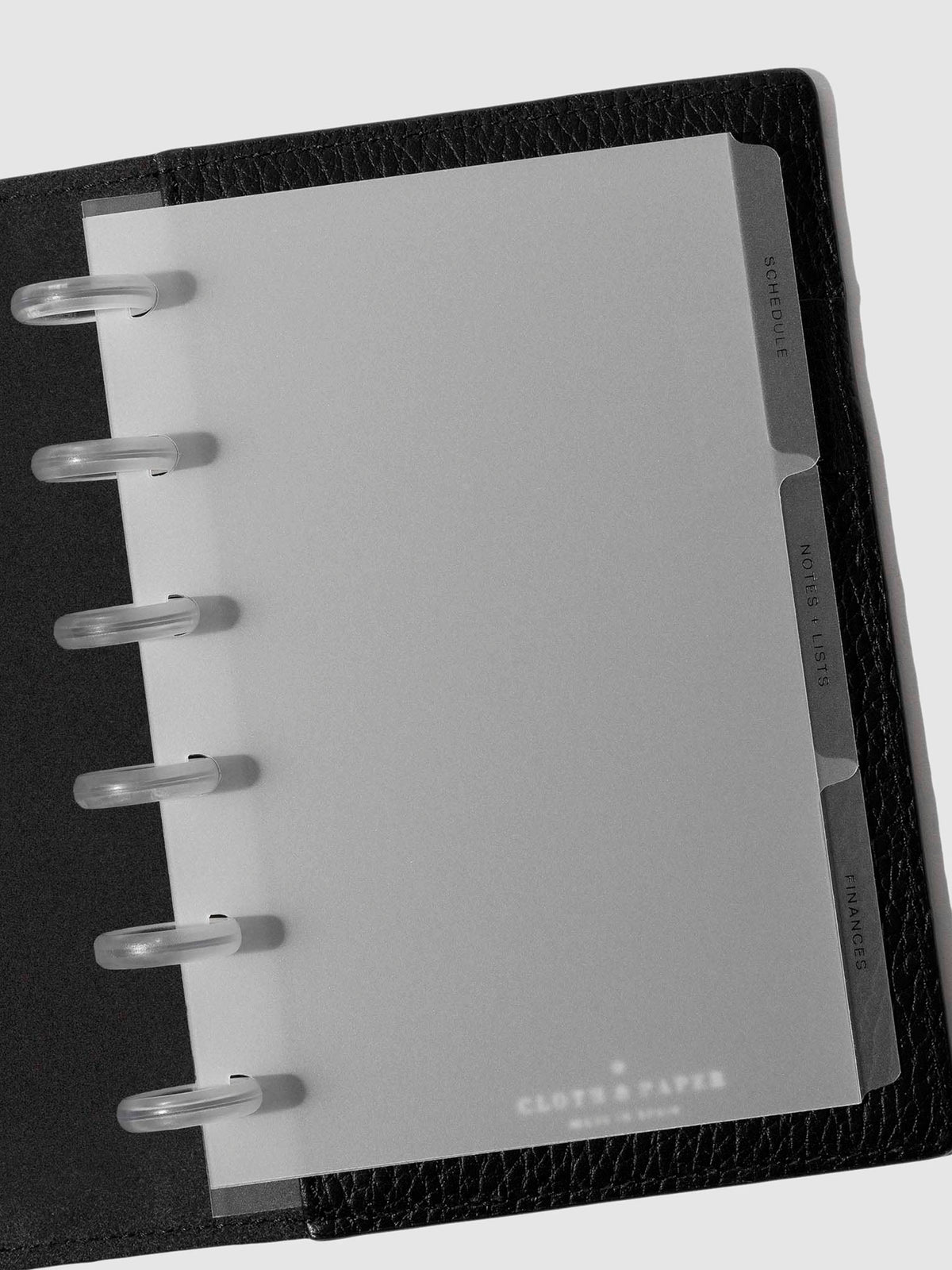 Black foil tabs displayed in use inside a leather folio.