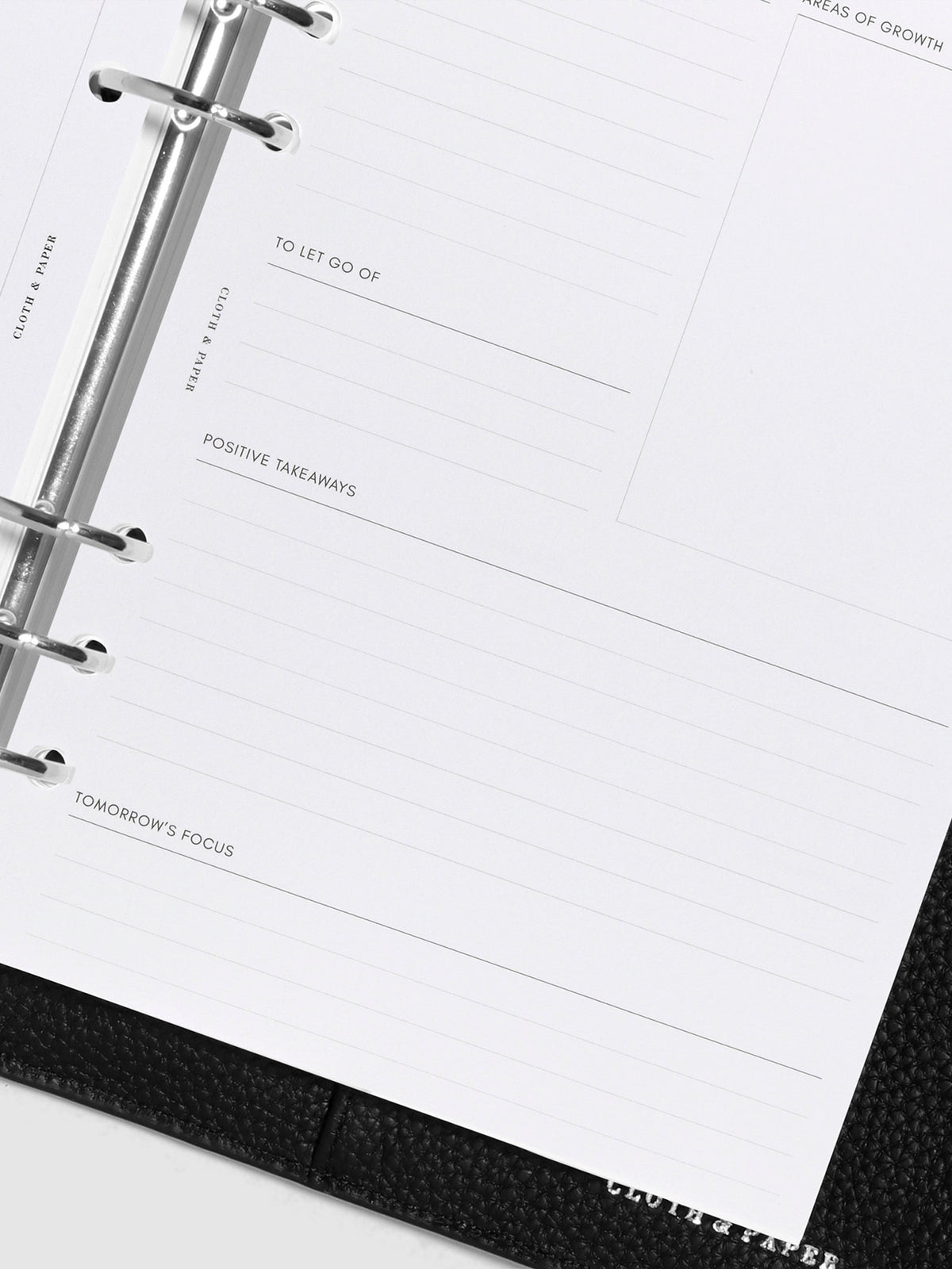 Closeup of inserts inside black leather agenda.