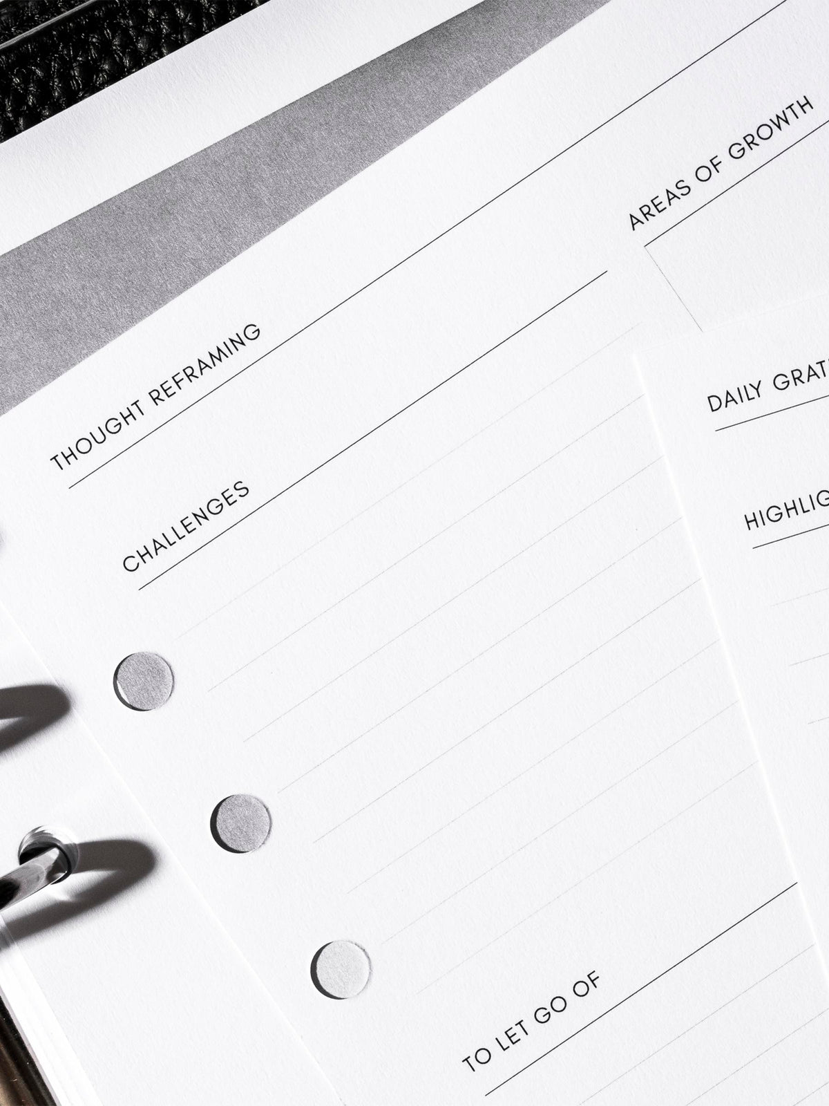 Closeup of inserts inside black leather agenda.