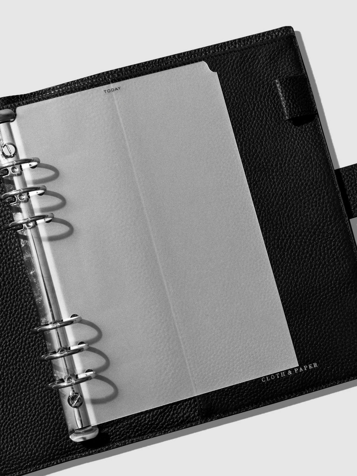 Divider in use inside a black leather planner.