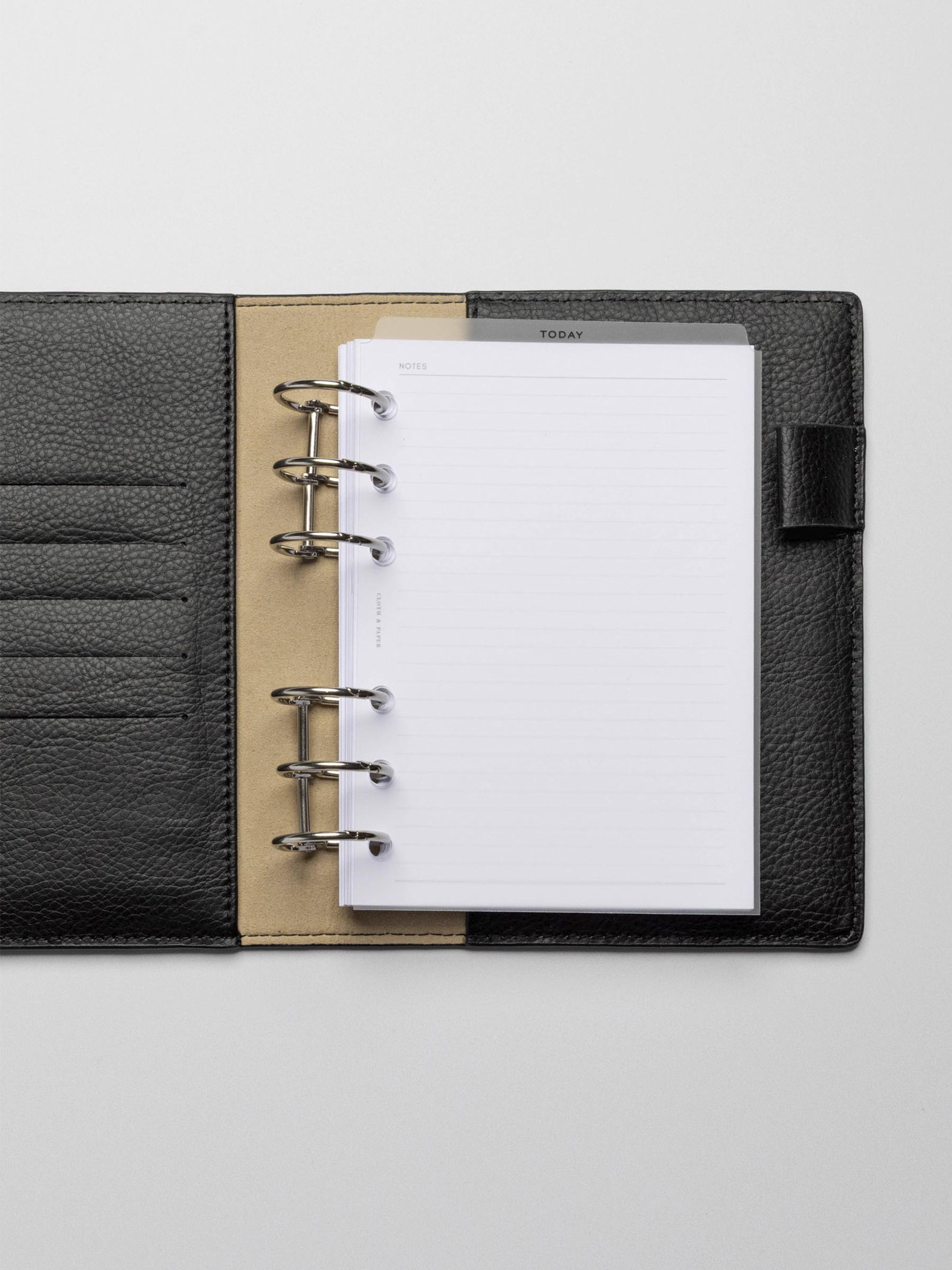 Black foil divider displayed in a black leather planner.