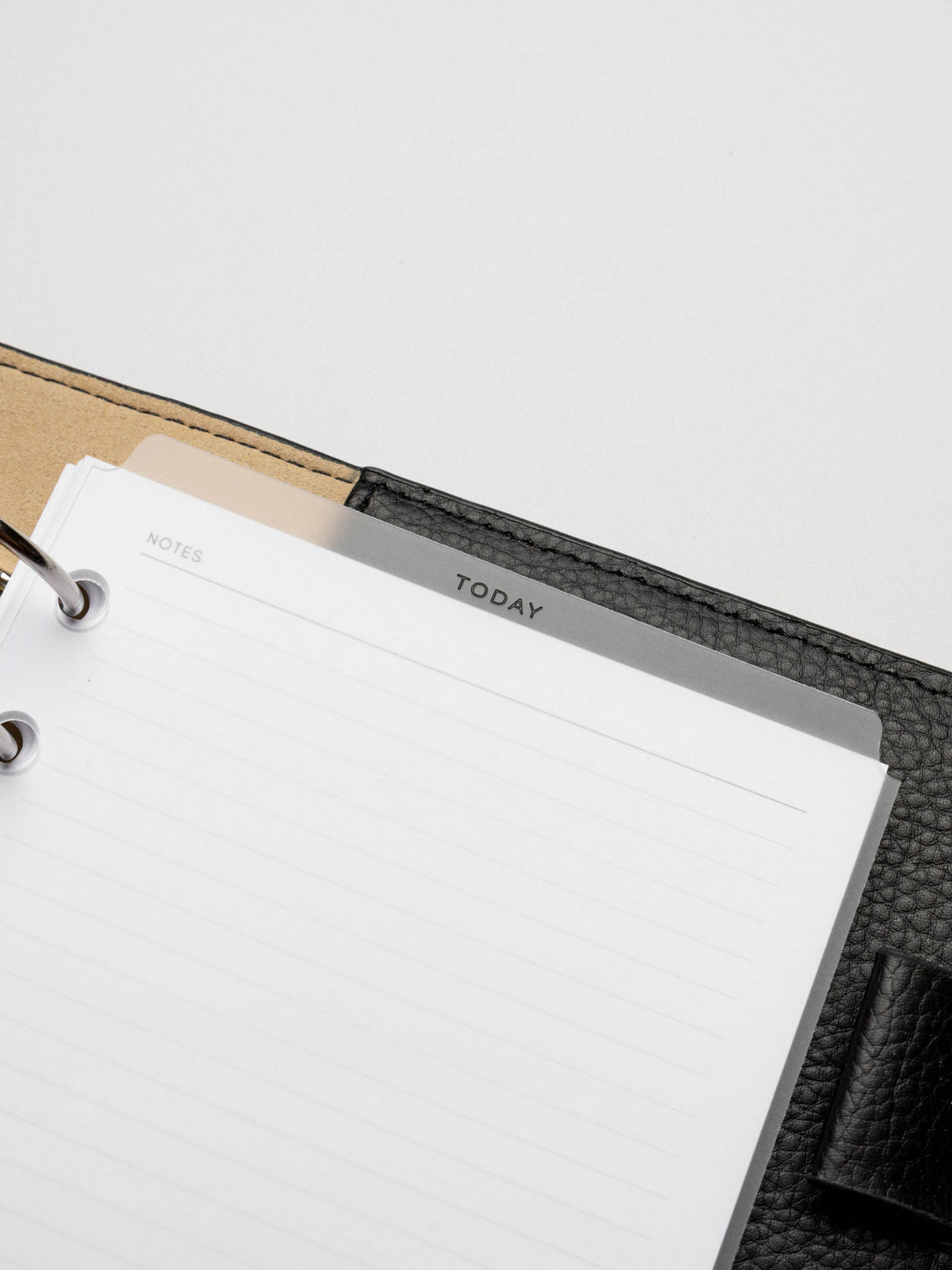 Divider in use inside a black leather planner.