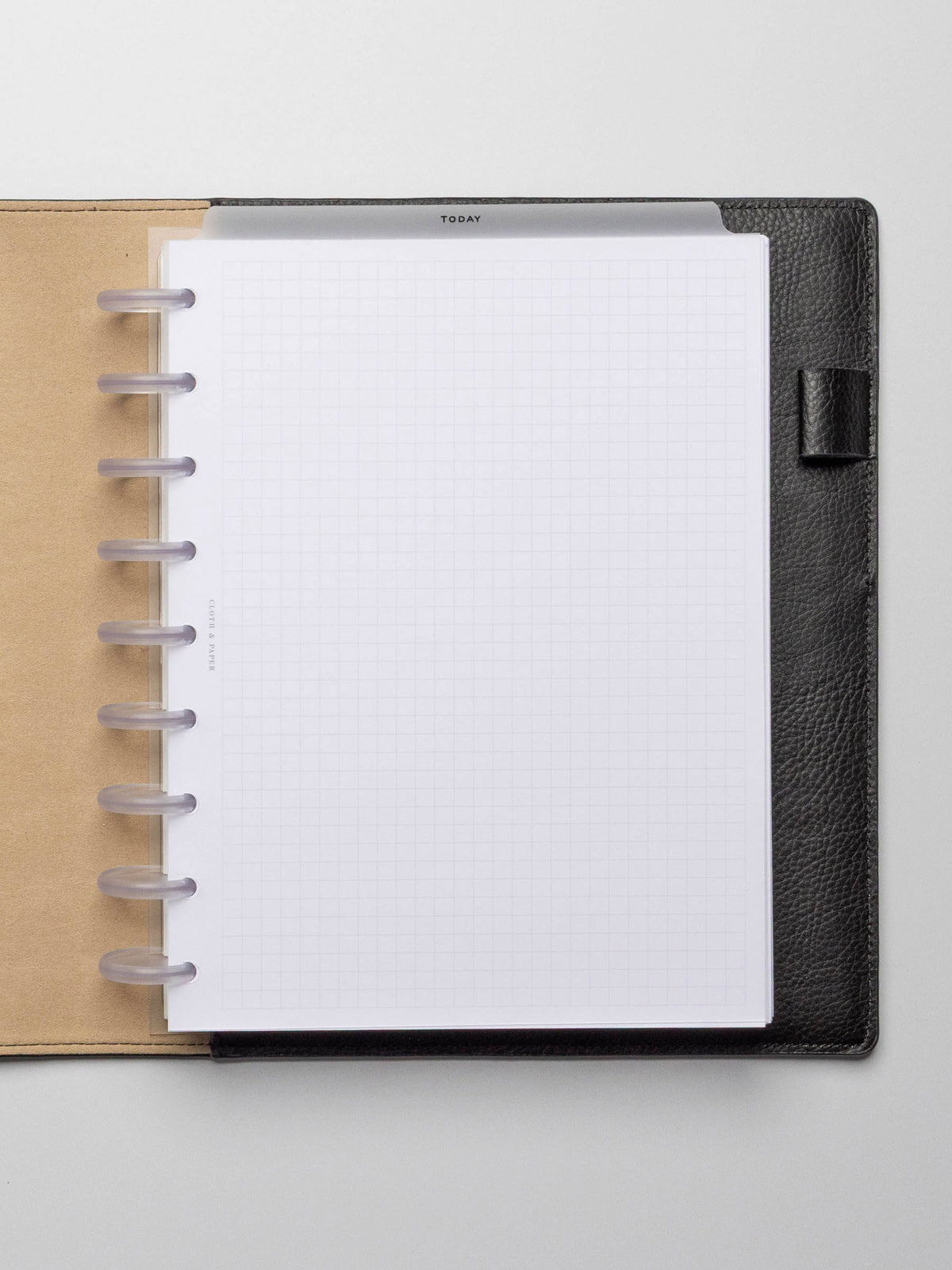 Black foil divider displayed in a black leather planner.