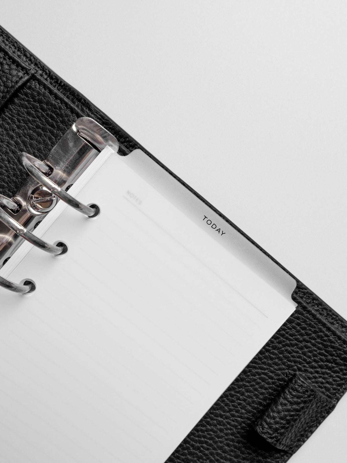 Divider in use inside a black leather planner.