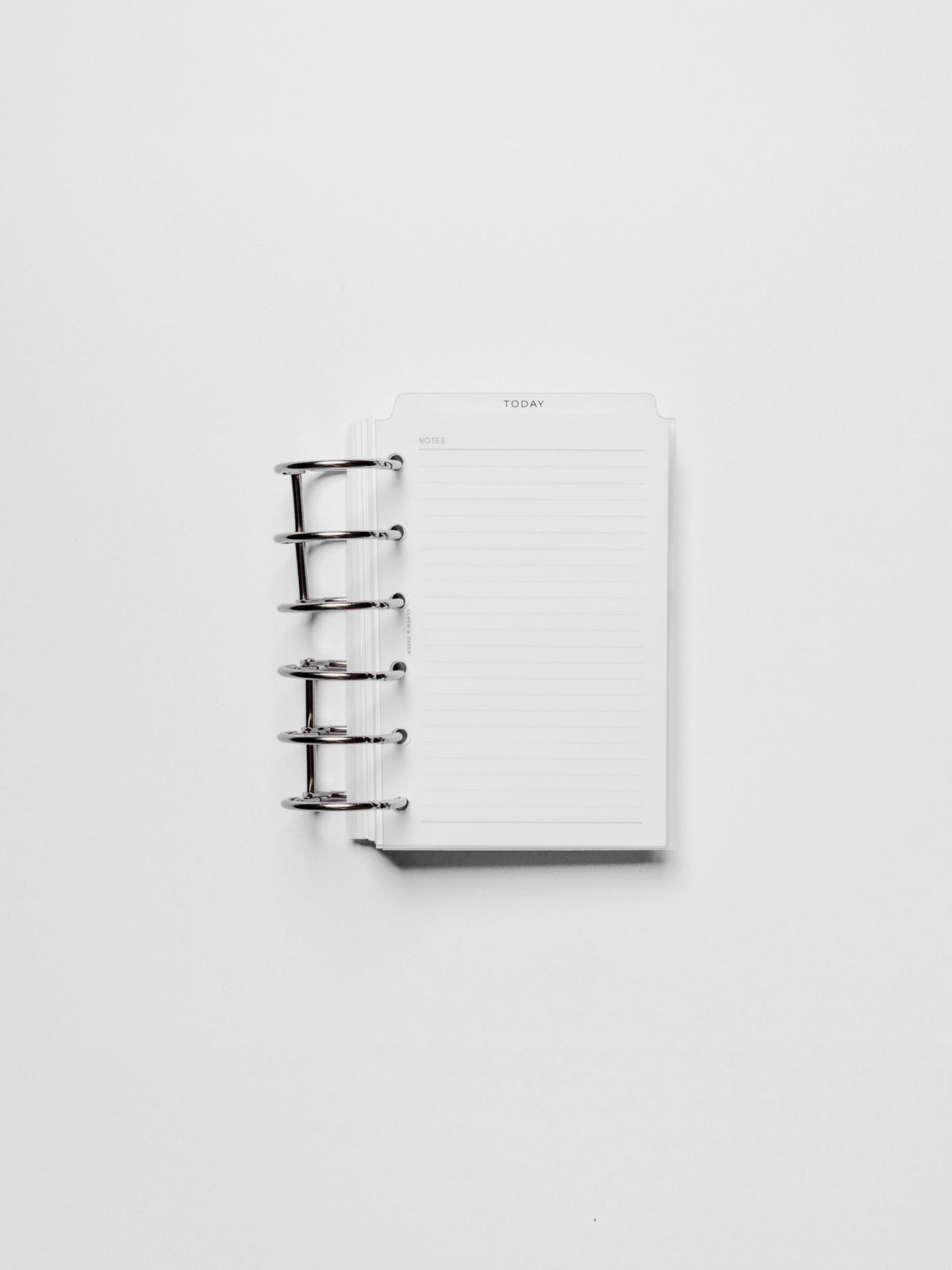 Black foil divider displayed in a metal ring.