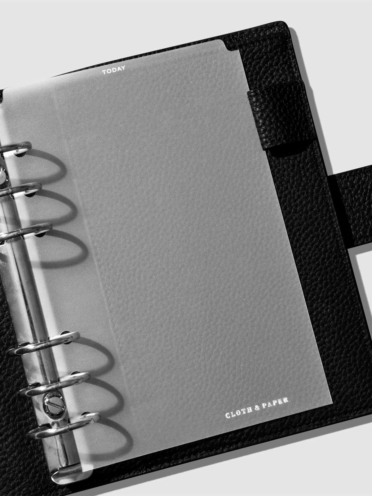 Divider in use inside a black leather planner.