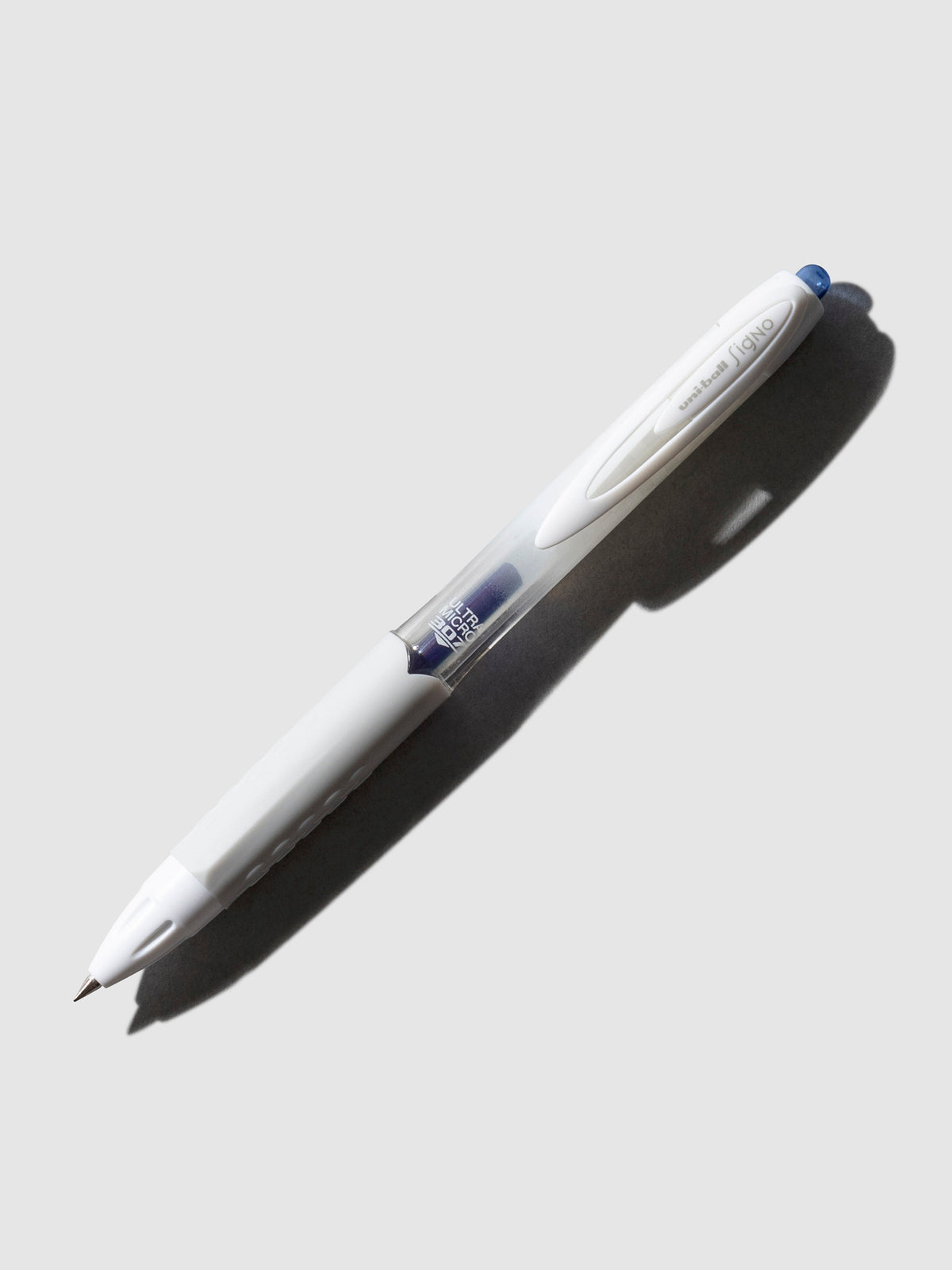 Uni-Ball Signo Gel Pen, 0.38 mm, blue, Cloth and Paper. Gel pen tilted slightly to the right on a neutral background.