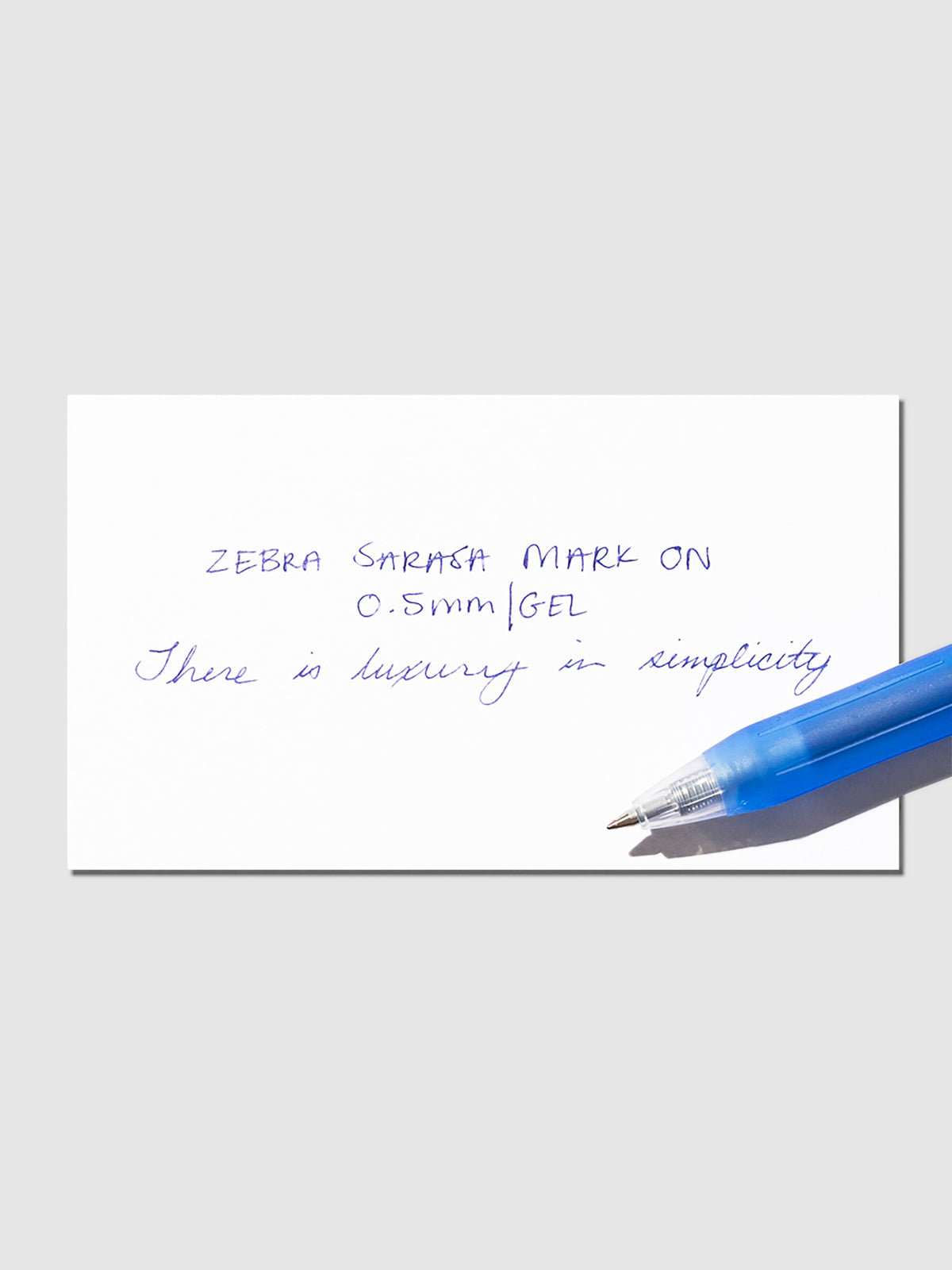 Blue pen displayed on top of a writing sample.