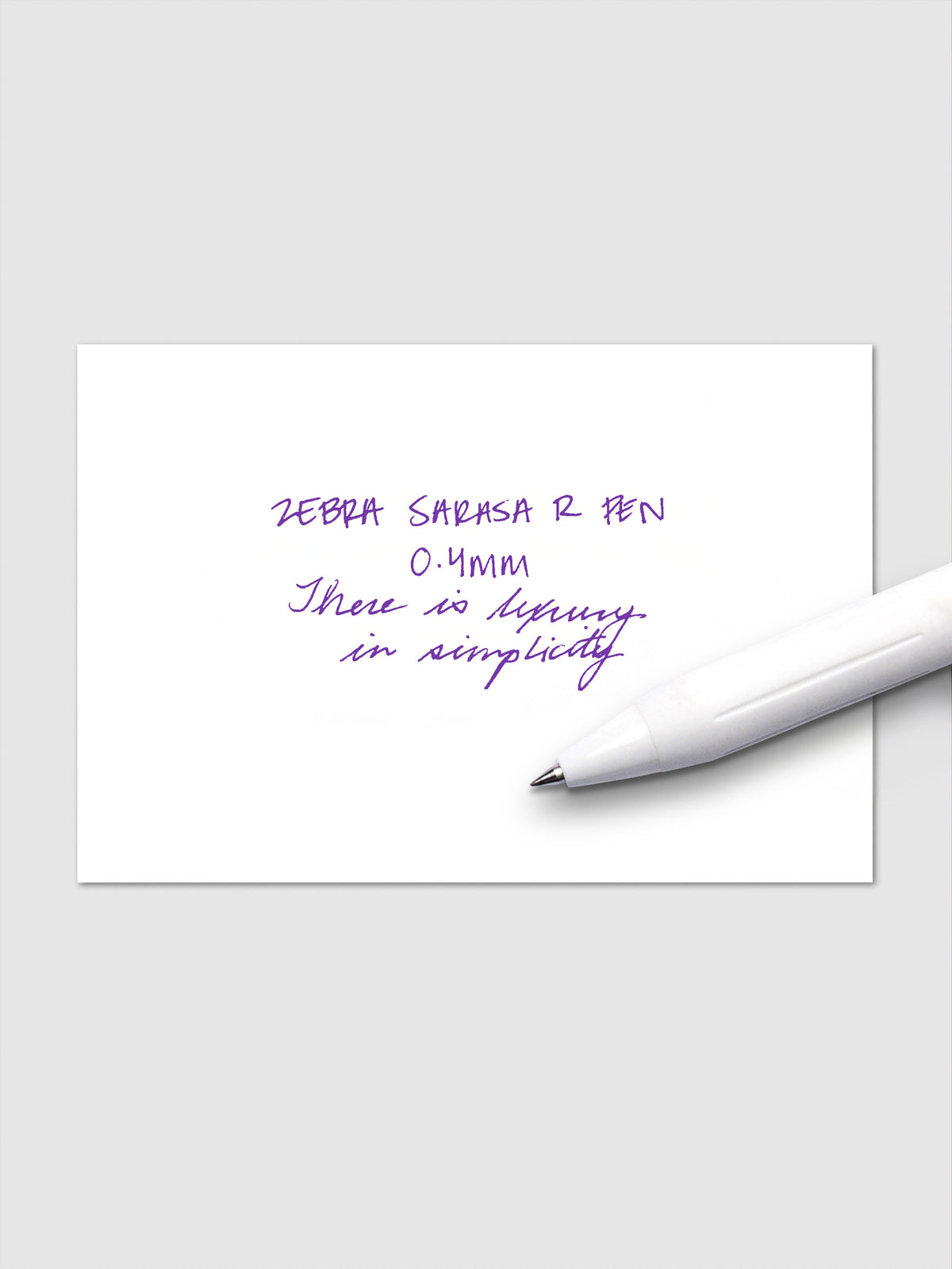 Writing sample using Zebra Sarasa R 0.4mm pen in violet ink on white paper.