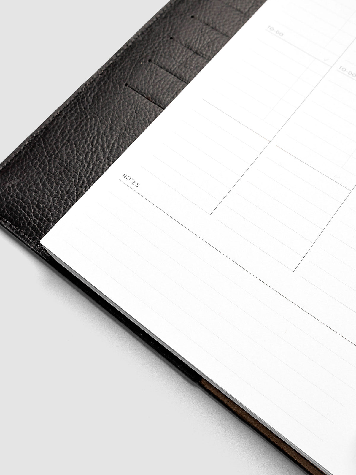 2027 Dated Weekly Task Planner Inserts, Monday Start, Half Letter 8-Disc Punch, close-up of the bottom of the left page showing open daily notes space and the weekly notes section along the bottom of the spread
