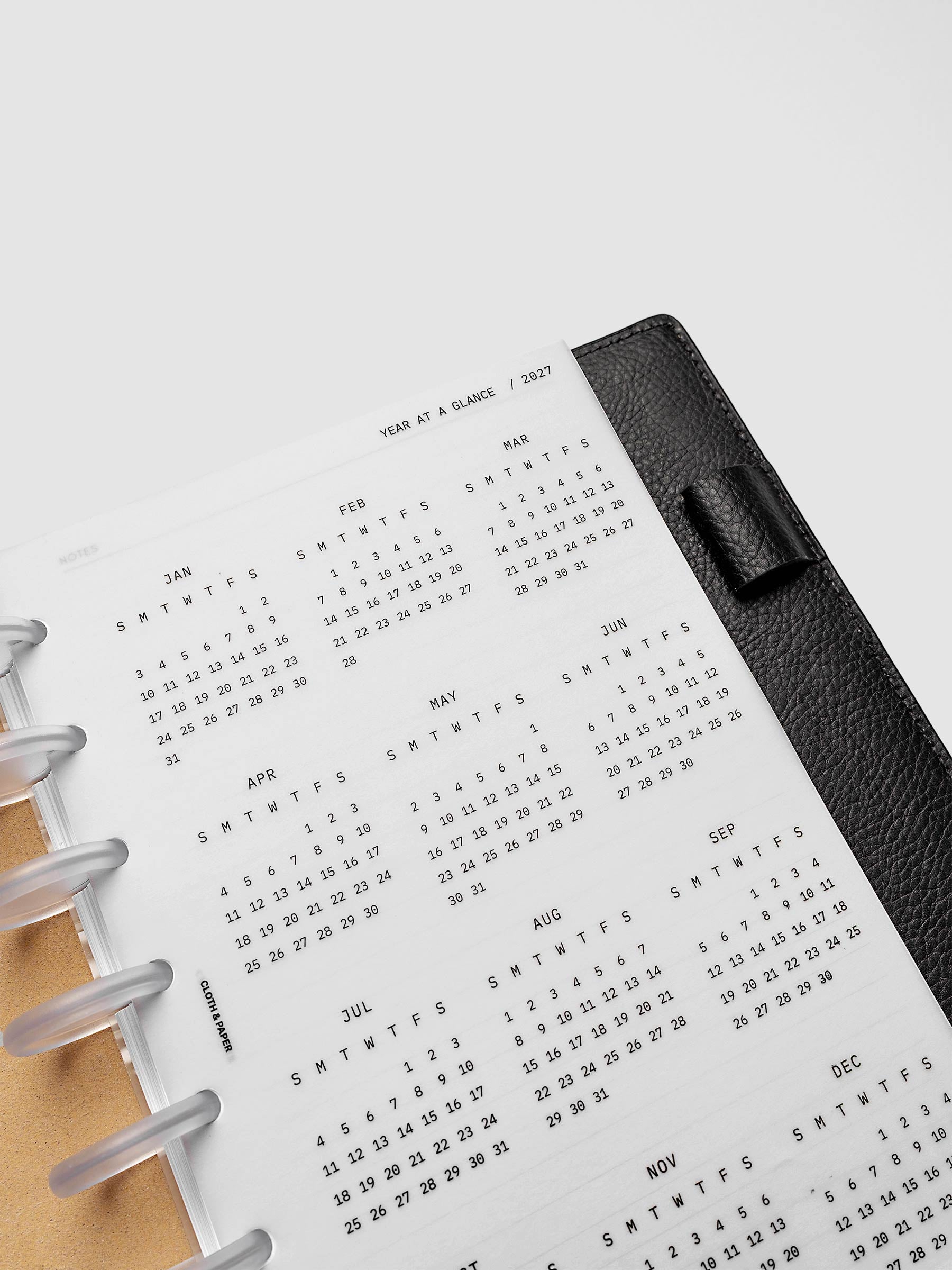 2027 Year At A Glance Dashboard Sunday Start, Half Letter 8-Disc Punch, close-up of the top of the vellum dashboard showing the first months of the 2027 year-at-a-glance calendar in Sunday-start format
