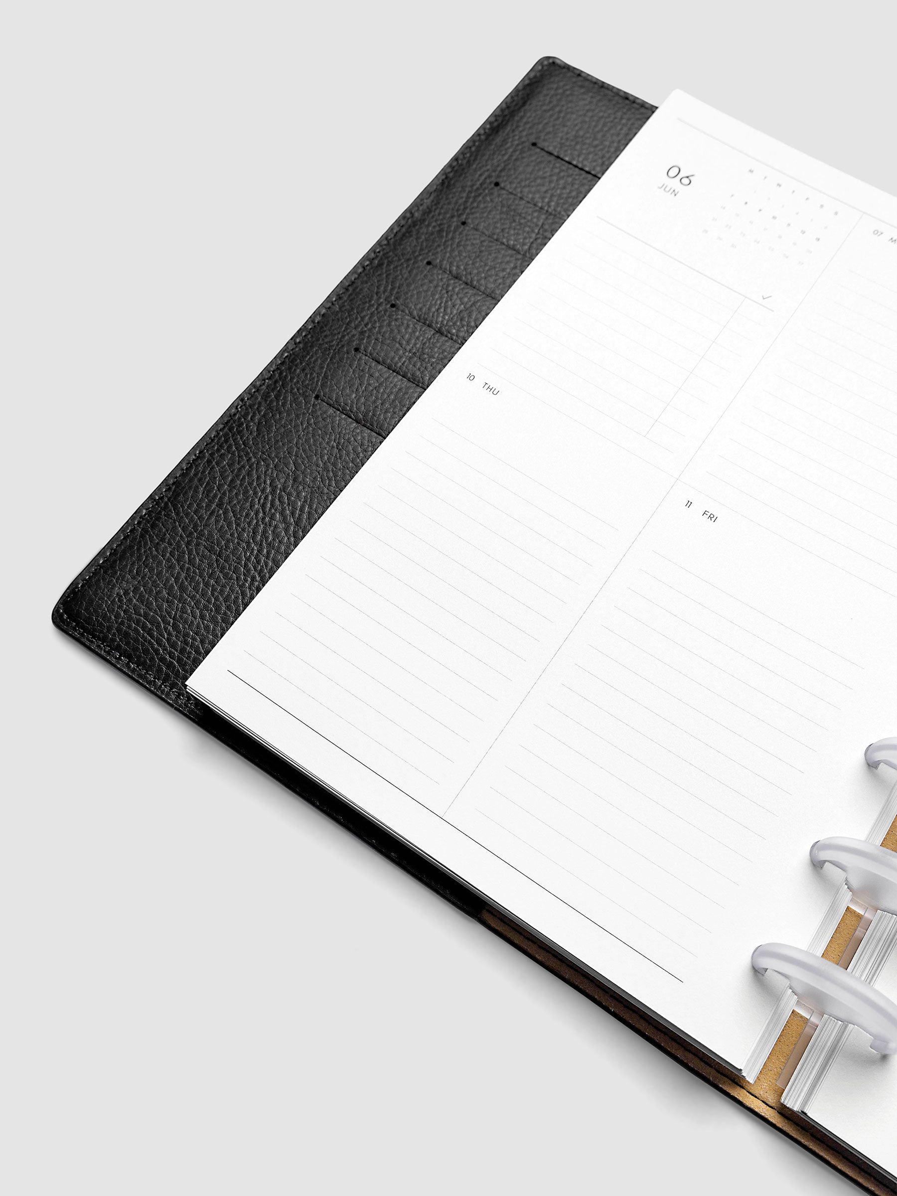 2027 Dated Weekly Vertical Planner Inserts, Monday Start, Half Letter 8-Disc Punch, close-up of the bottom of the left page showing the lower daily grid sections with lined areas for notes and appointments
