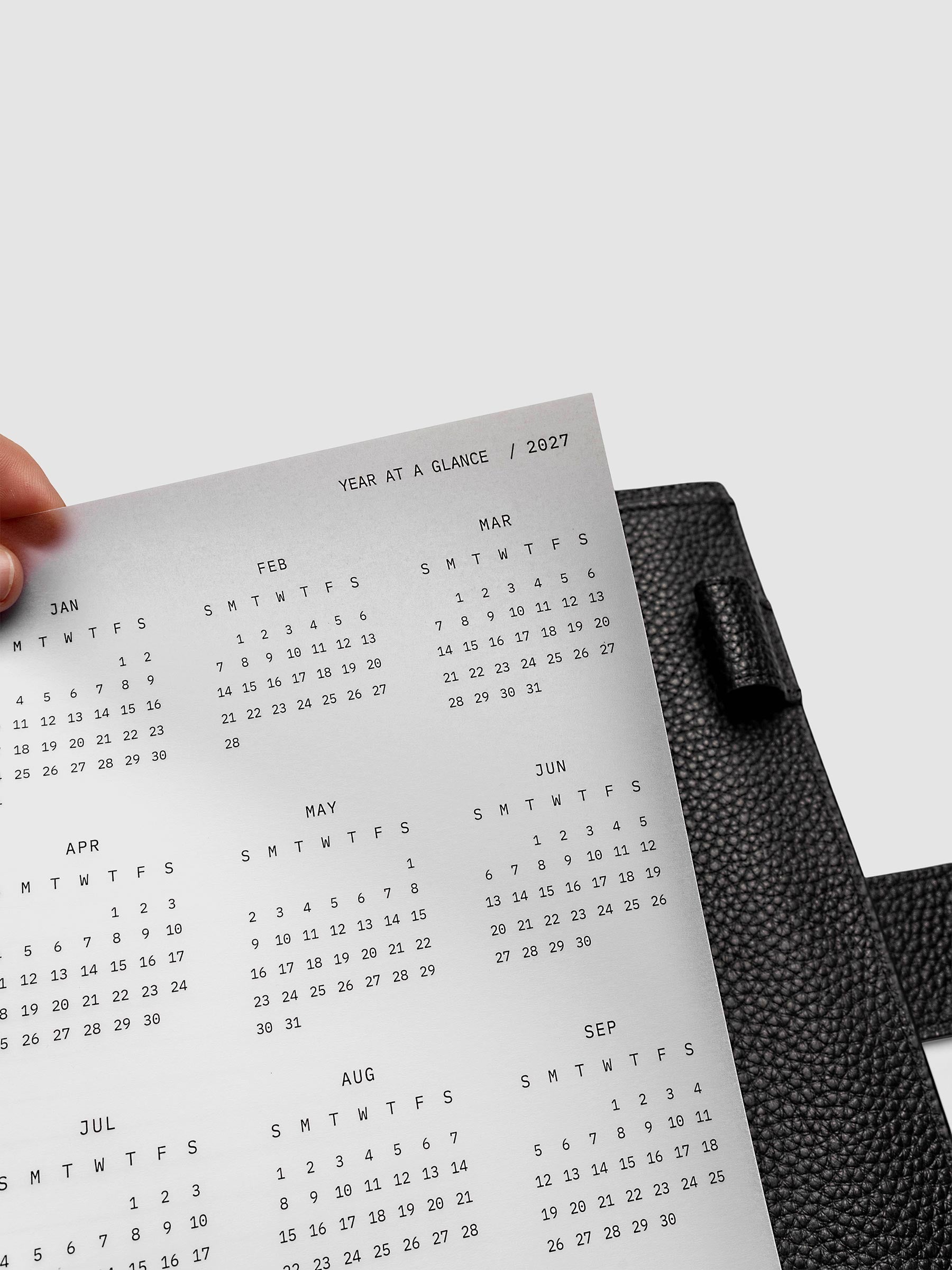 2027 Year At A Glance Dashboard Sunday Start, Half Letter 8-Disc Punch, close-up of the top right corner of the vellum dashboard showing calendar month detail and Sunday-start grid layout