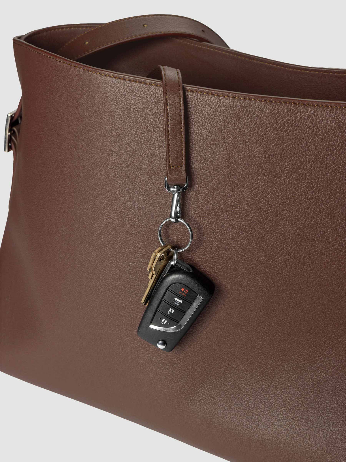 Detail view of the key leash with keys attached on The Metro Tote in the color Cordoba.