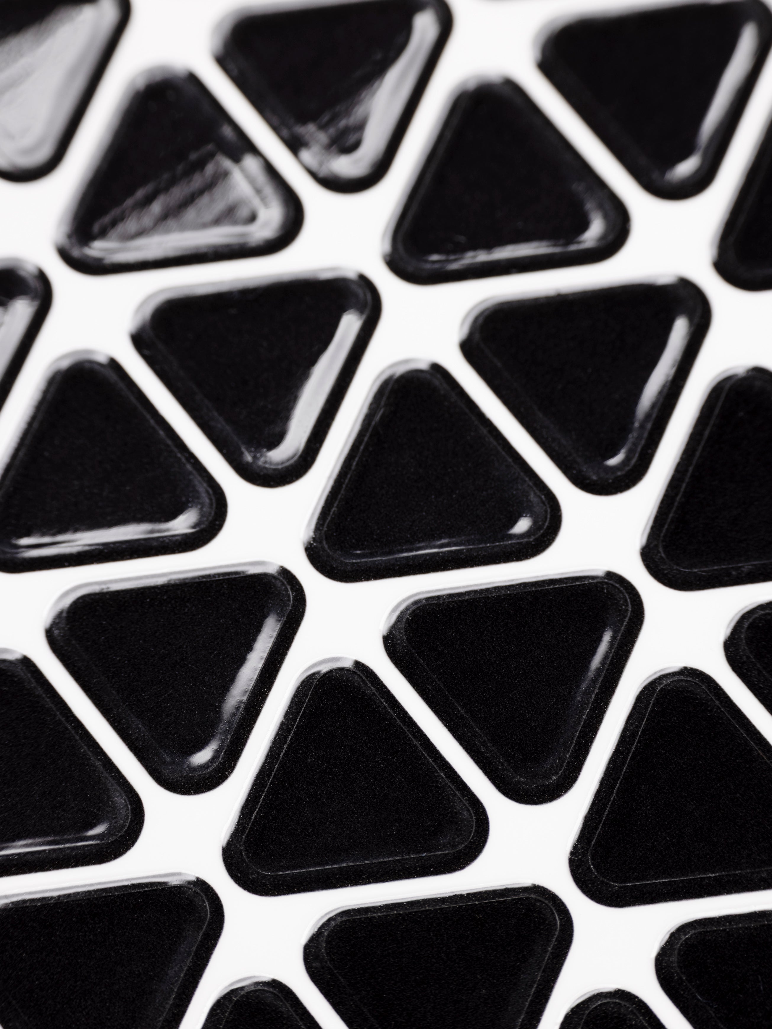 Close up of a sheet of high gloss, black triangle planner stickers