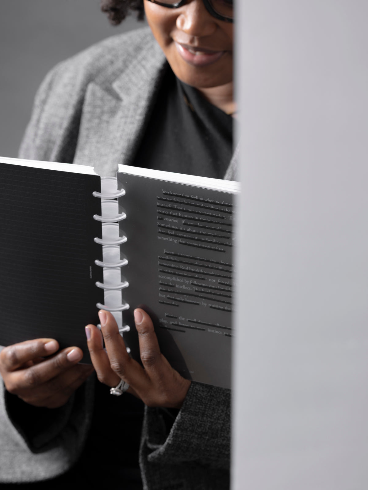A woman holding a discbound planner with the Hidden Message Planner Dashboard Duo showing