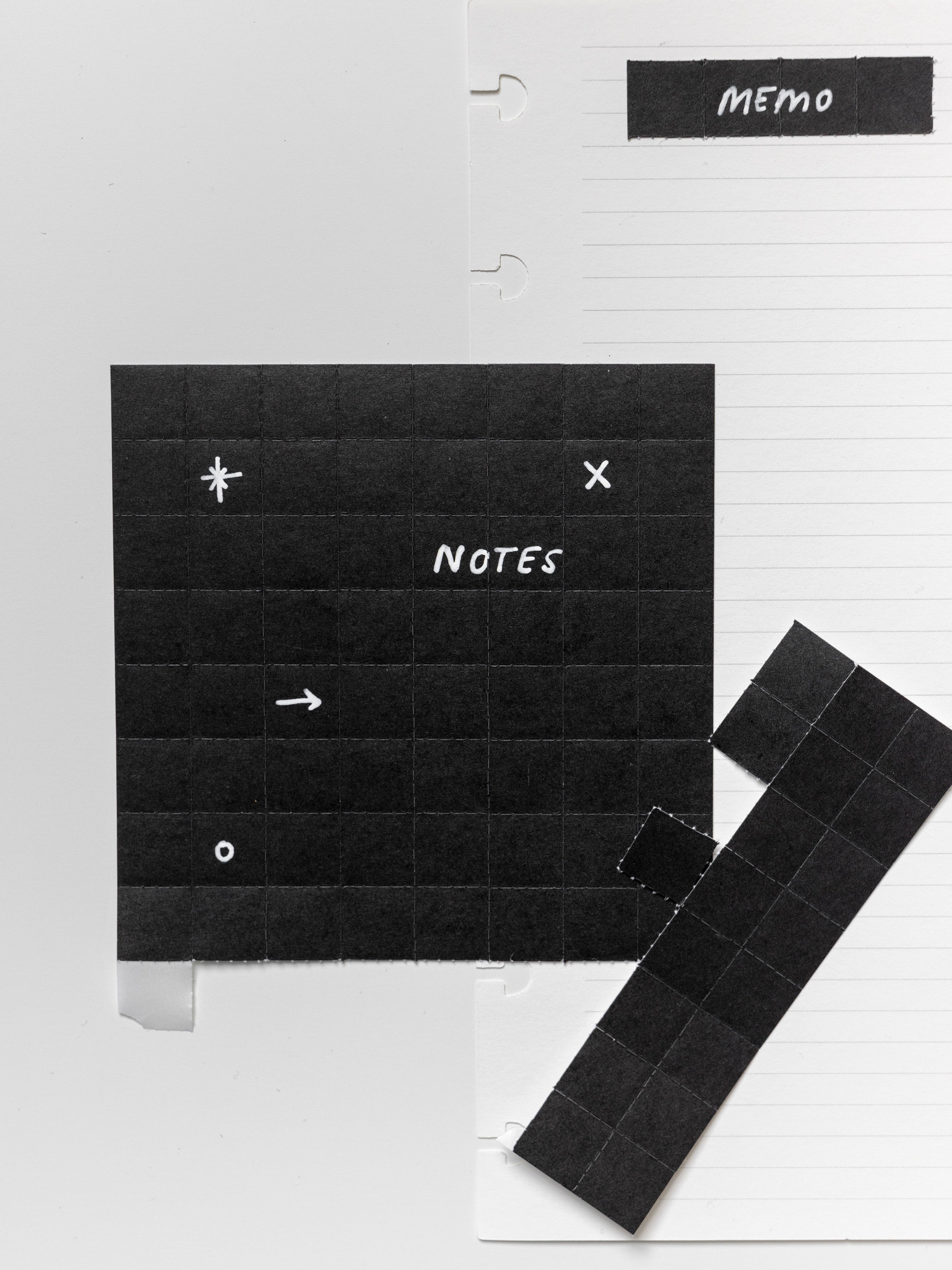 Black tear off stickers with white text