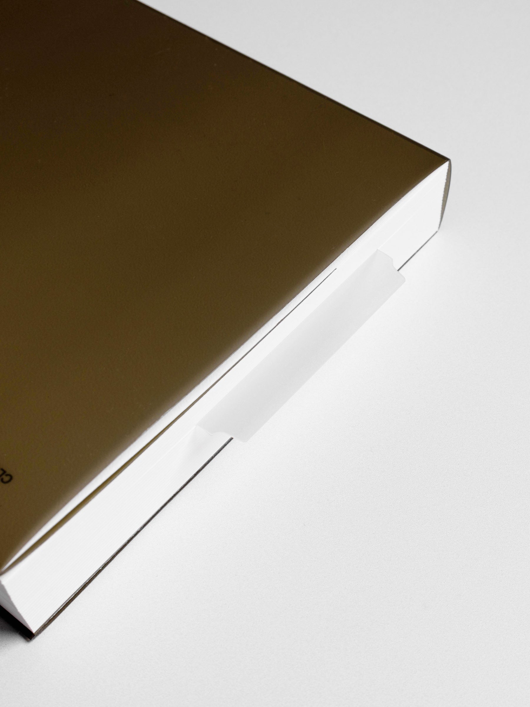 Page marker in use in a perfect bound notebook.