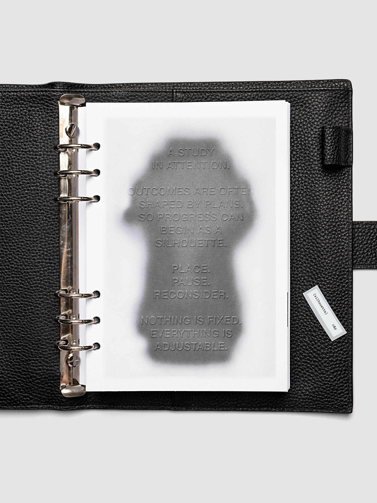 Silhouette Planner Dashboard in A5 6-Ring Punch. Greyscale silhouette print with embossed text on paper. Image 2 of 4.
