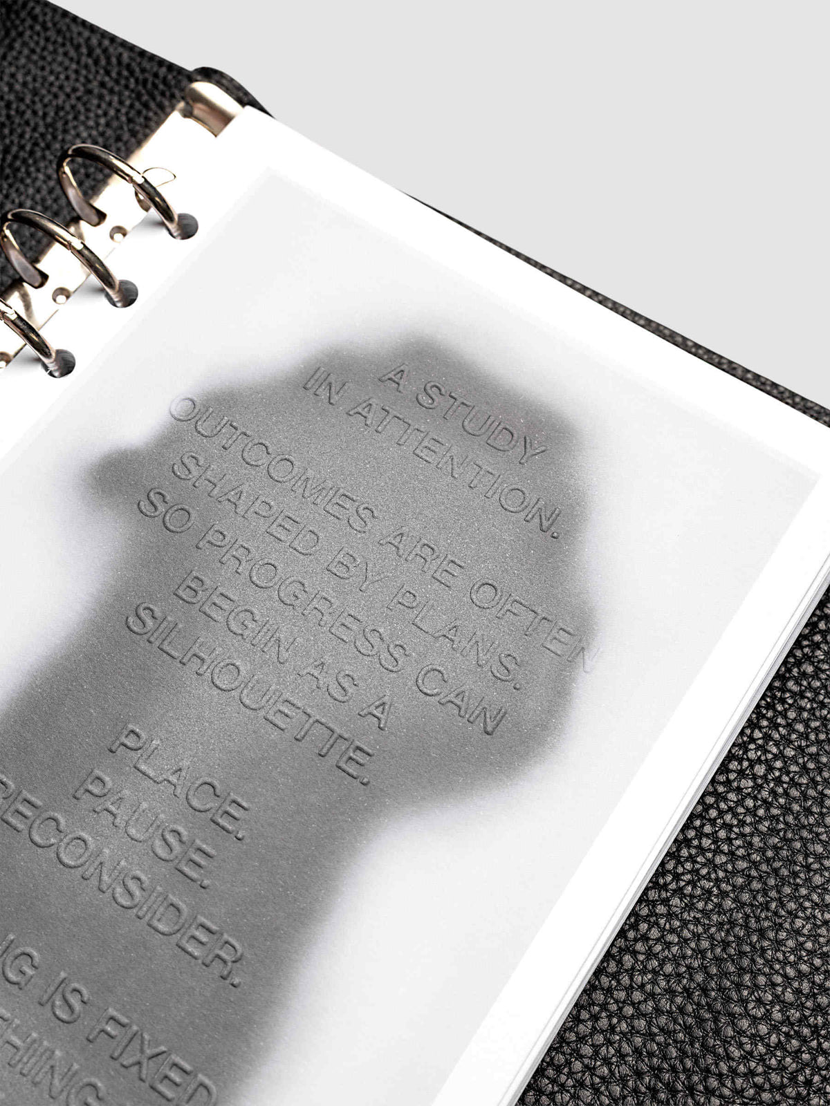 Silhouette Planner Dashboard in A5 6-Ring Punch. Greyscale silhouette print with embossed text on paper. Image 4 of 4.