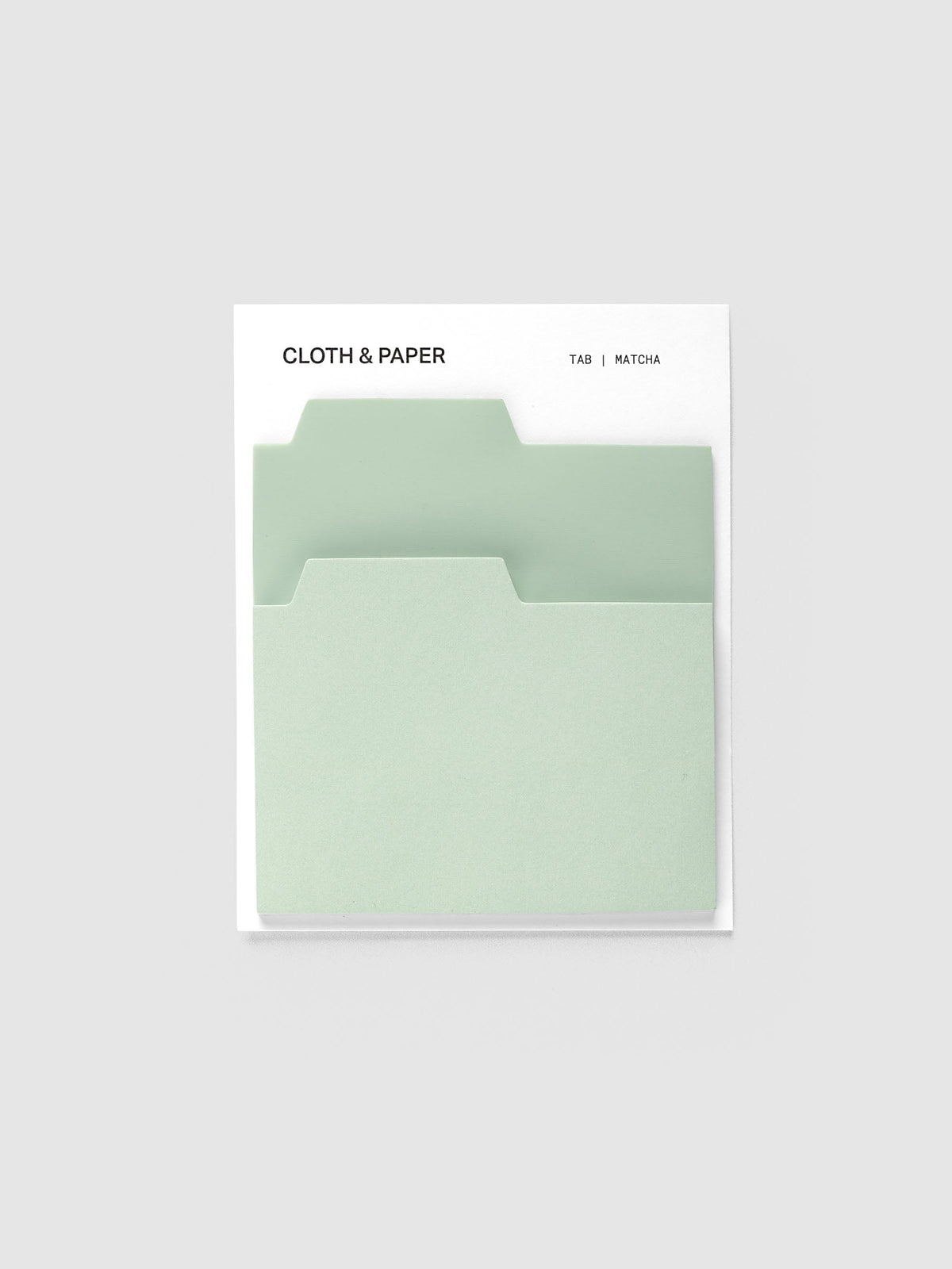 Blank Tab Sticky Note Set, Matcha, Cloth and Paper. Set on its backing card, a transparent pale green pad behind a matte pale green pad with the tabs staggered.