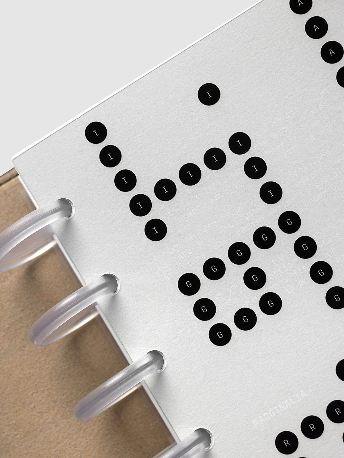 Scantron Dashboard Duo, Half Letter 8-Disc Punch, angled close-up of the frosted discs and the black lettered bubbles