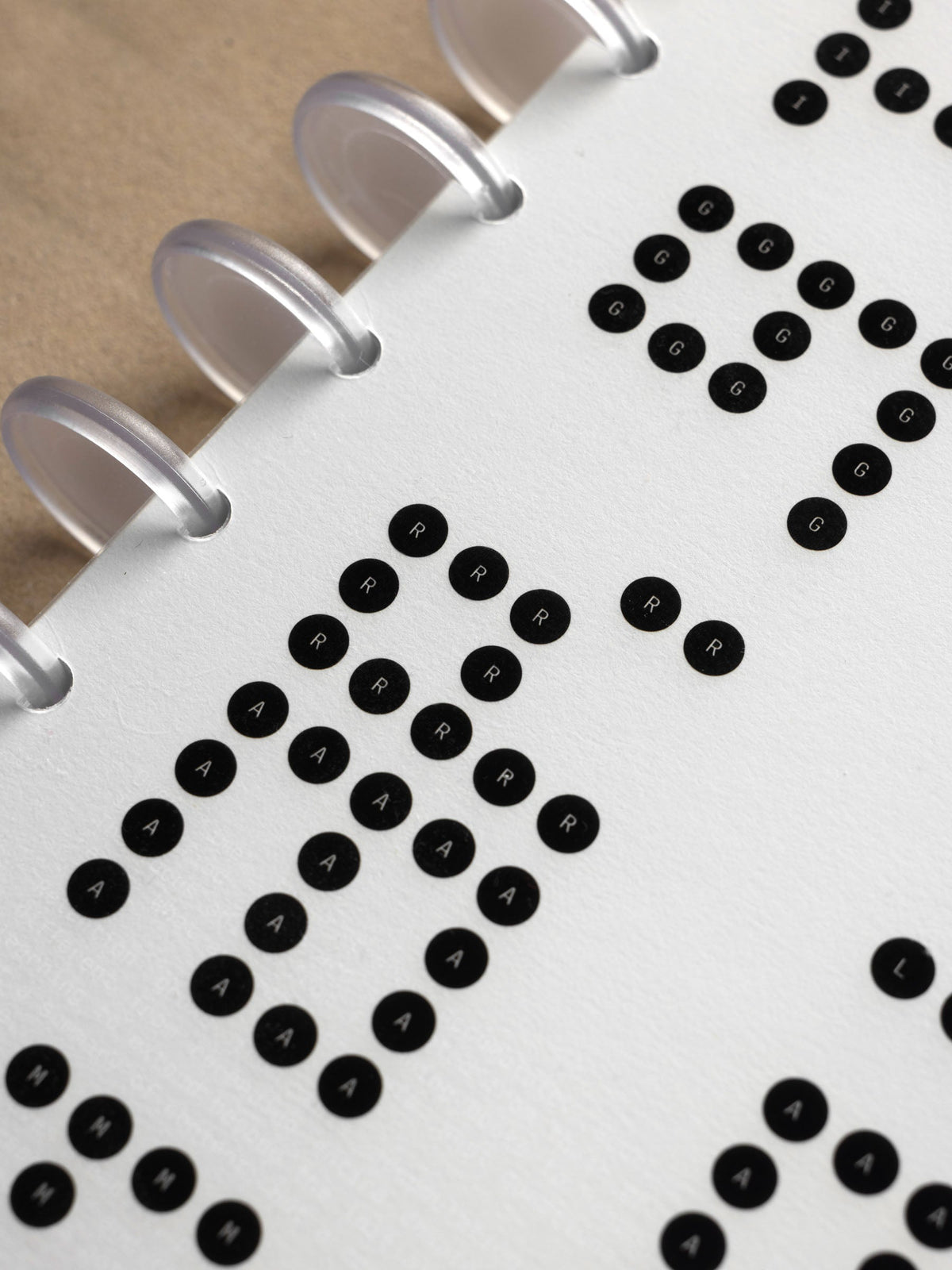 Scantron Dashboard Duo, Half Letter 8-Disc Punch, angled close-up of the bubbles beside the frosted discs and kraft panel