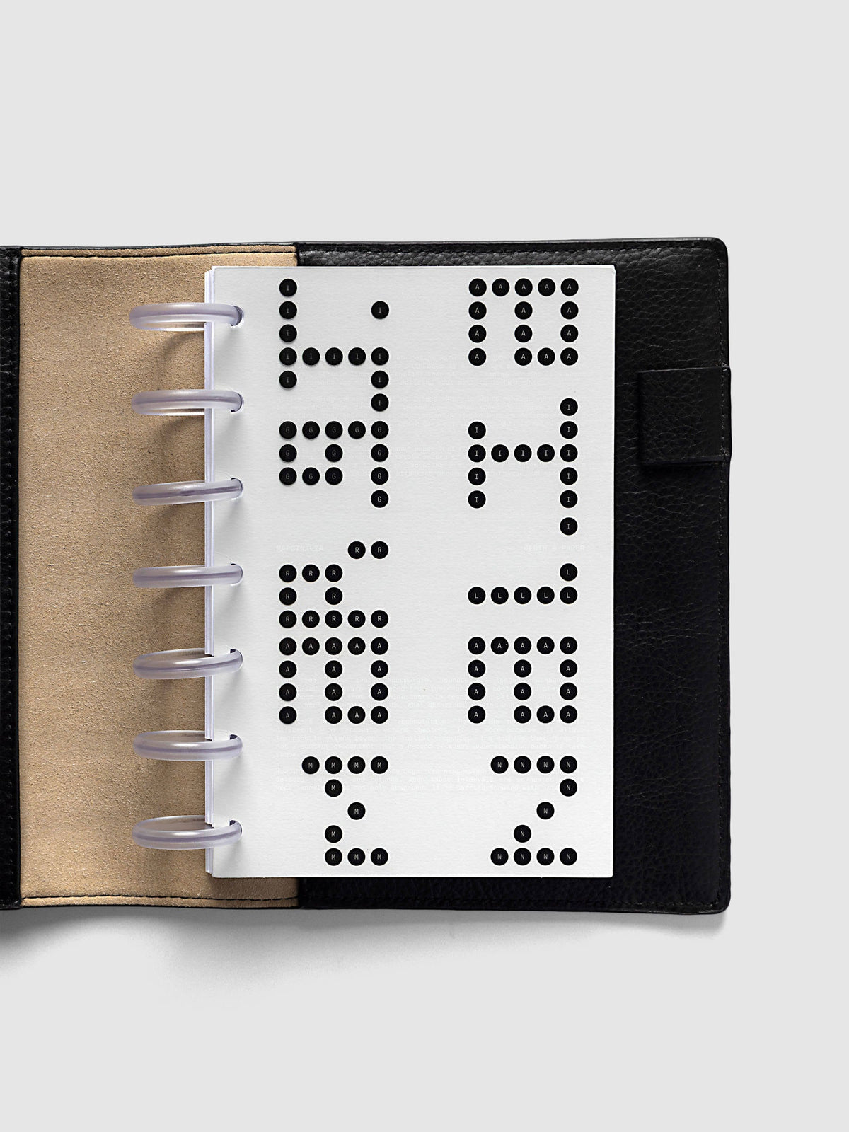 Scantron Dashboard Duo, HP Mini 7-Disc Punch, the dashboard pair on frosted discs in an open black leather planner with a kraft interior panel