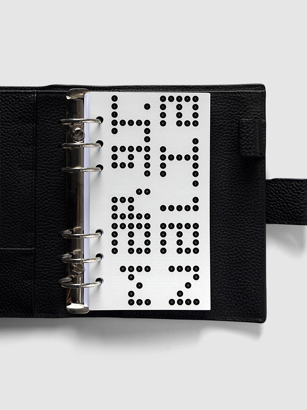 Scantron Dashboard Duo, Personal 6-Ring Punch, the dashboard pair on the rings of an open black leather planner