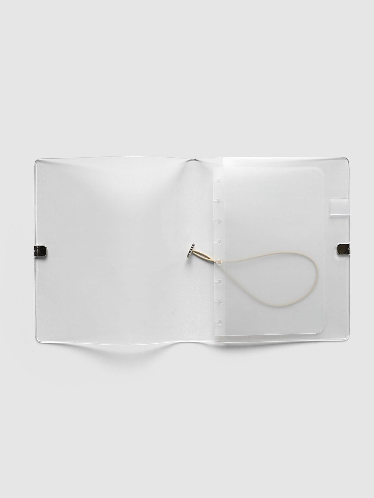 Folio Cover in frosted vinyl, Large (Half Letter 8-Disc Punch), open flat showing the punched disc strip and the beige bungee cord inside