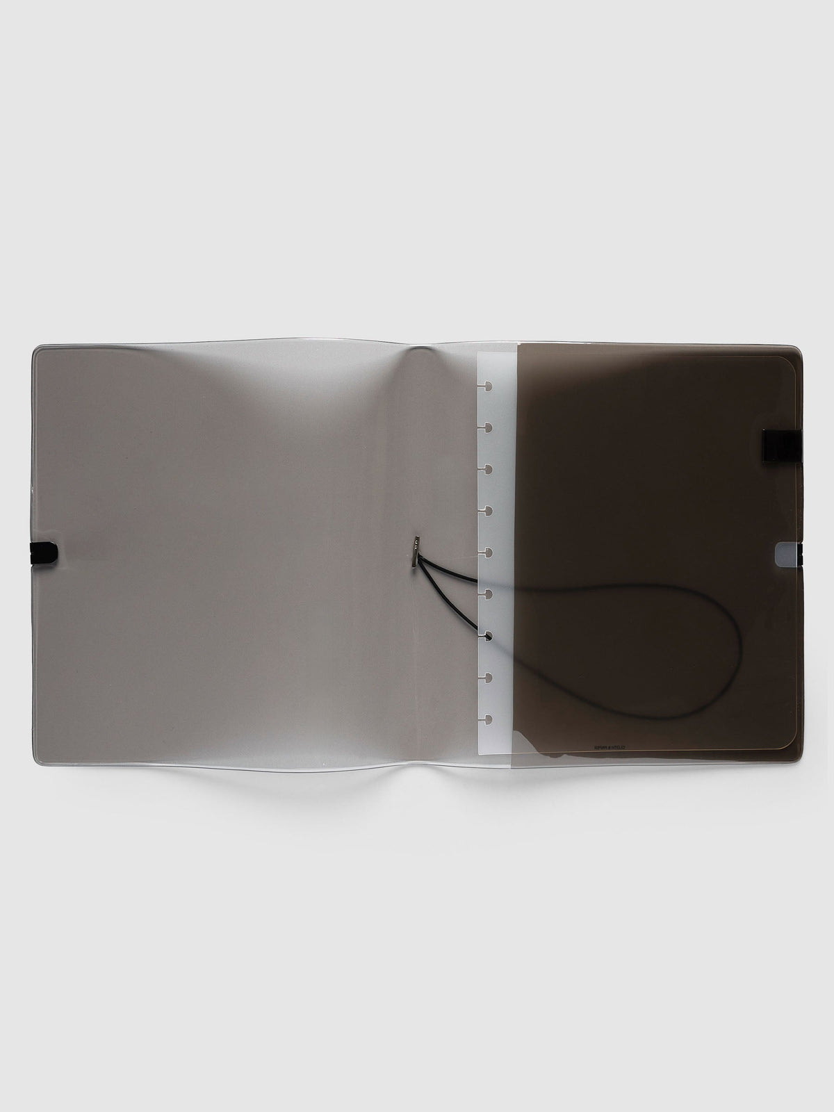 Folio Cover in black tinted vinyl, HP Classic (HP Classic 9-Disc Punch), open flat showing the punched disc strip and the black bungee cord inside