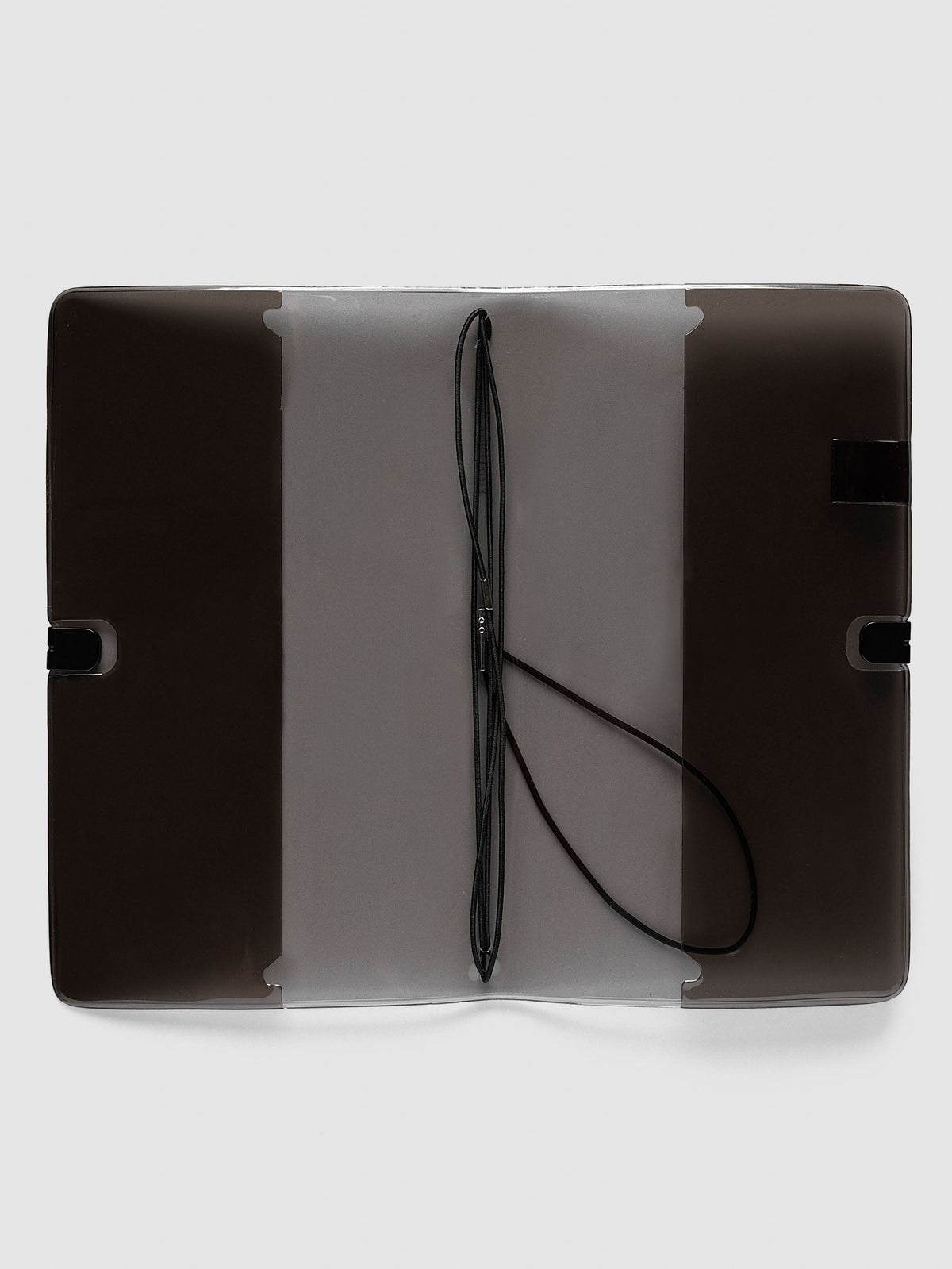 Image Duo Travel Cover, A5 Slim, open flat showing the frosted center panel, black elastic insert bands with silver metal ends and black clip tabs